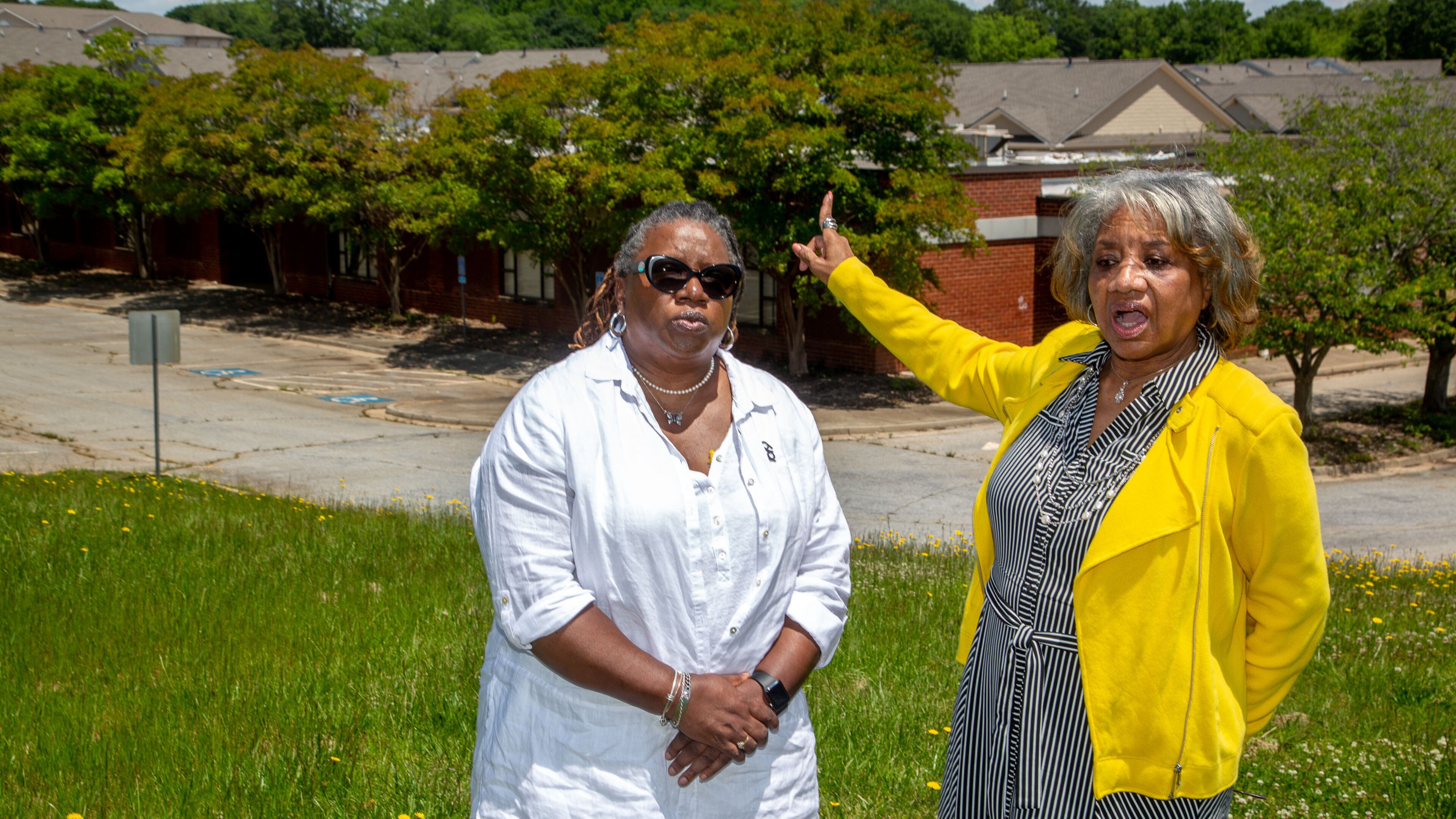 Theresa Bailey (L) and Joyce Moore stand in front of the old Hooper-Renwick School on May 11 and talk about why preserving the memory of the Lawrenceville school is essential. Bailey and Moore, both former students of the school, serve as chair and vice chair of a committee dedicated to preserving the Hooper-Renwick building. STEVE SCHAEFER FOR THE ATLANTA JOURNAL-CONSTITUTION
