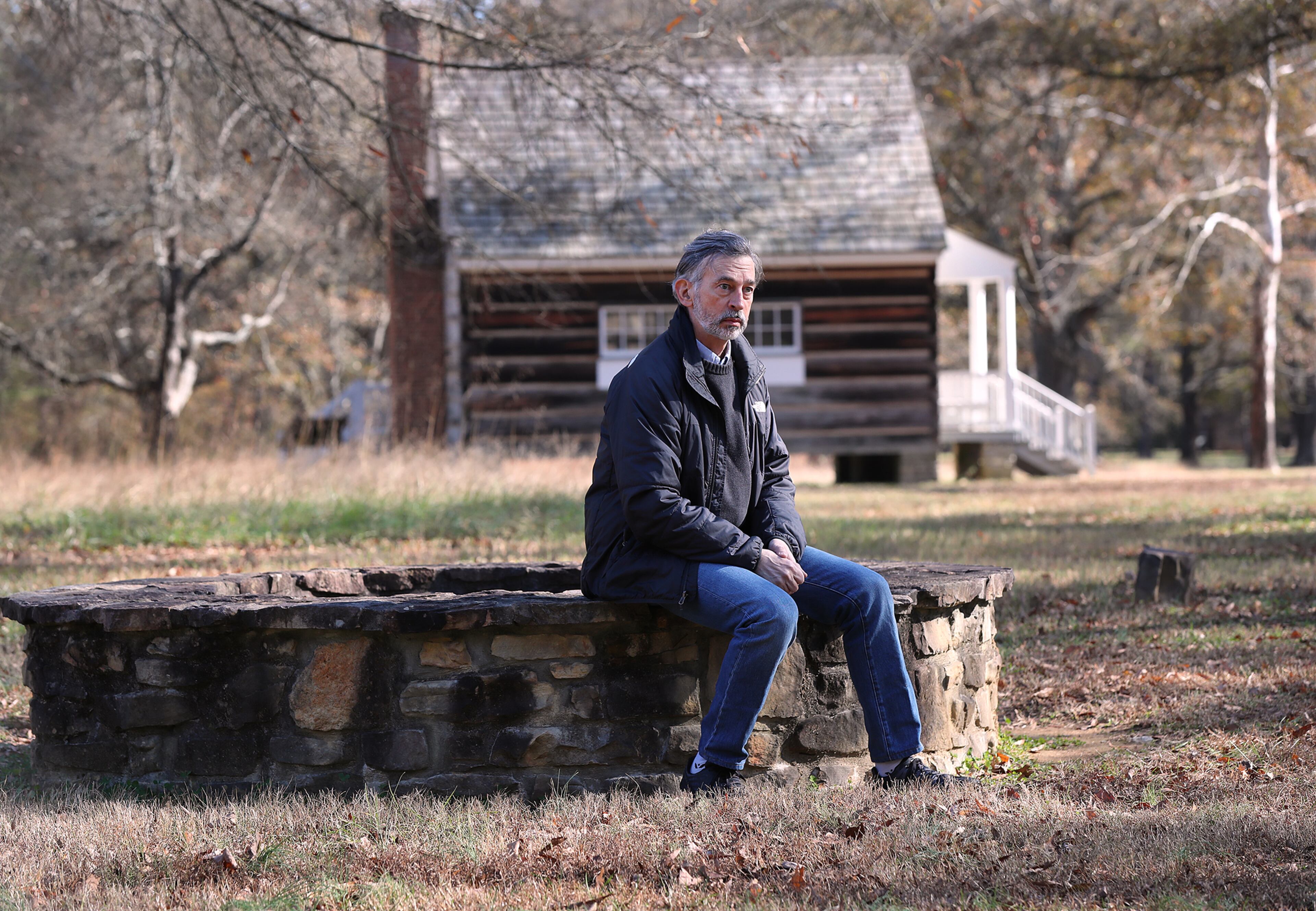 120820 Calhoun: Cherokee Indian decendant John Perry sits on the original well at the Boudinot house site where the Treaty of New Echota was signed at the New Echota Historic Site on Tuesday, Dec. 8, 2020, in Calhoun. New Echota is one of the most significant Cherokee Indian sites in the nation and marks the beginning of the tragic Trail of Tears. “Curtis Compton / Curtis.Compton@ajc.com”