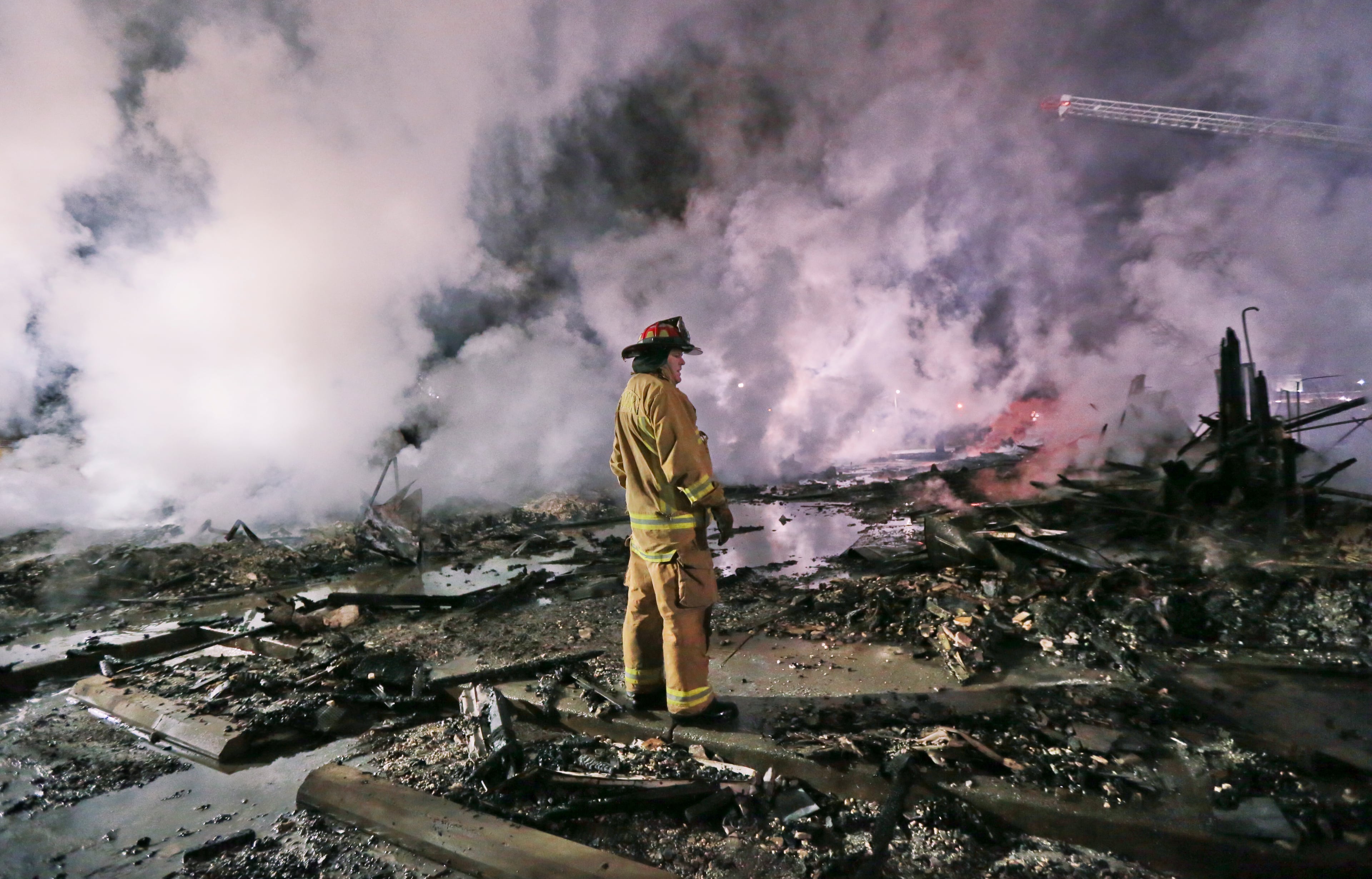 February 5, 2013 Atlanta: Fulton County Fire captain Stan Hudgins looks for hotspots to guide aerial ladder operations. Fire officials on Tuesday, Feb. 5, 2013 said homeless people trying to stay warm might have sparked a huge overnight blaze that gutted a vacant south Fulton County motel. The fire was reported shortly before 1:30 a.m. at the former InHome Suites extended stay motel on Interchange Drive off Fulton Industrial Boulevard, just across Martin Luther King Jr. Drive from Fulton County Airport-Brown Field. Fulton fire Deputy Chief Jack Butler told the Atlanta Journal-Constitution that the two-story, wood-frame motel had been vacant for about two years. The motel's two buildings had "no power and no gas," he said. Butler said that when firefighters arrived, the buildings were about 50 to 70 percent consumed by flames. "With that much involvement, it's just trying to keep it contained," Butler said. "It was all wood, so it had plenty of fuel."While the cause of the fire hadn't been determined, Butler speculated that it was "probably vagrants keeping warm, something like that.""This is an area where you do have some homeless people," Butler said. "It's cold, and people are going to find a way to try to stay warm." He said that even though the motel was boarded up, "if there's a way for people to get in, they will." Butler said firefighters had found no victims in the rubble. "We'll talk with some of the homeless people in the area to make sure there is nobody that's missing, but as far as we know, there was nobody in there," he said. JOHN SPINK / JSPINK@AJC.COM