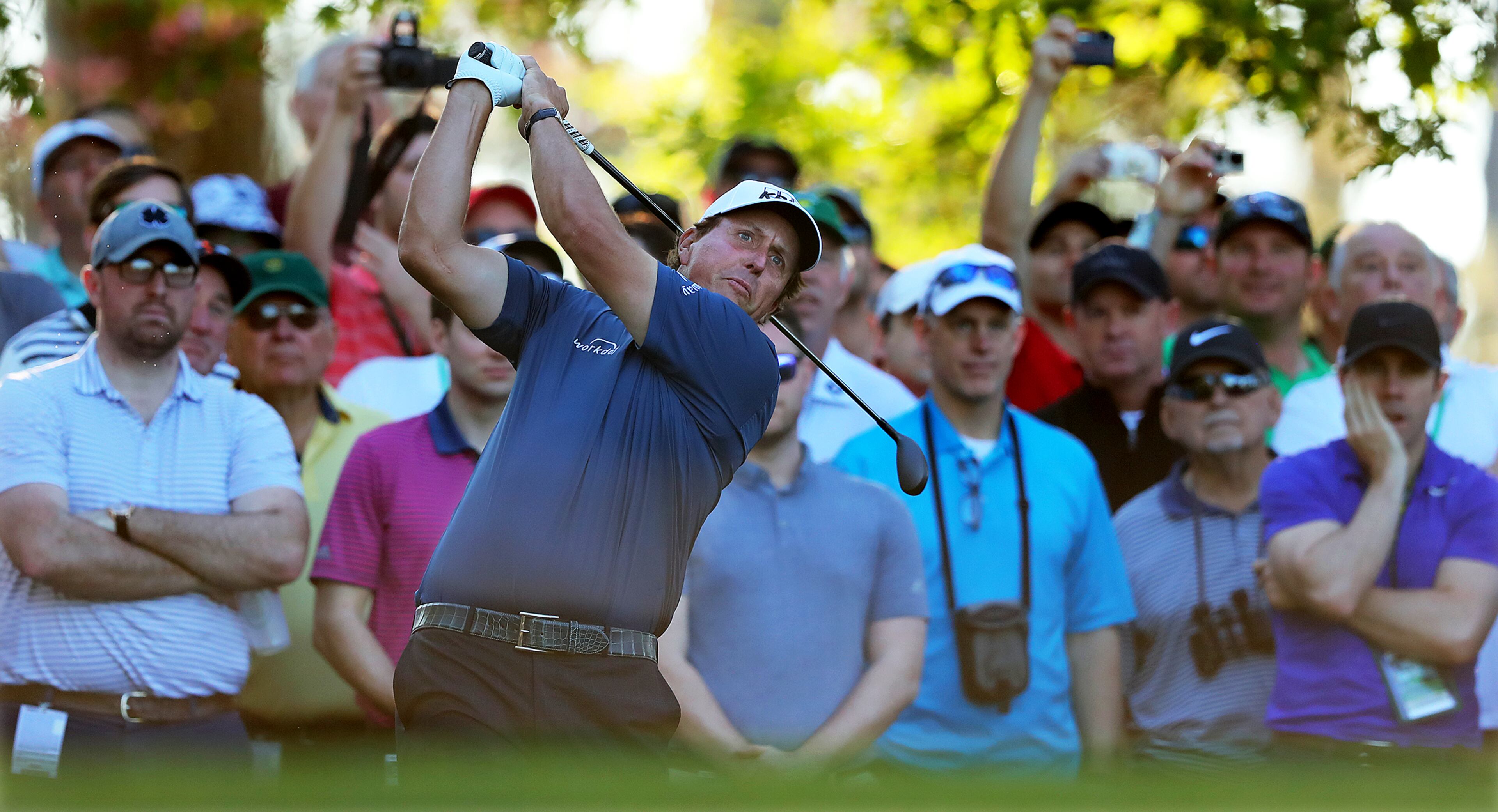 The gallery looks on as Phil Mickelson tees off on the fourth hole on his way to a birdie during his practice round Tuesday.