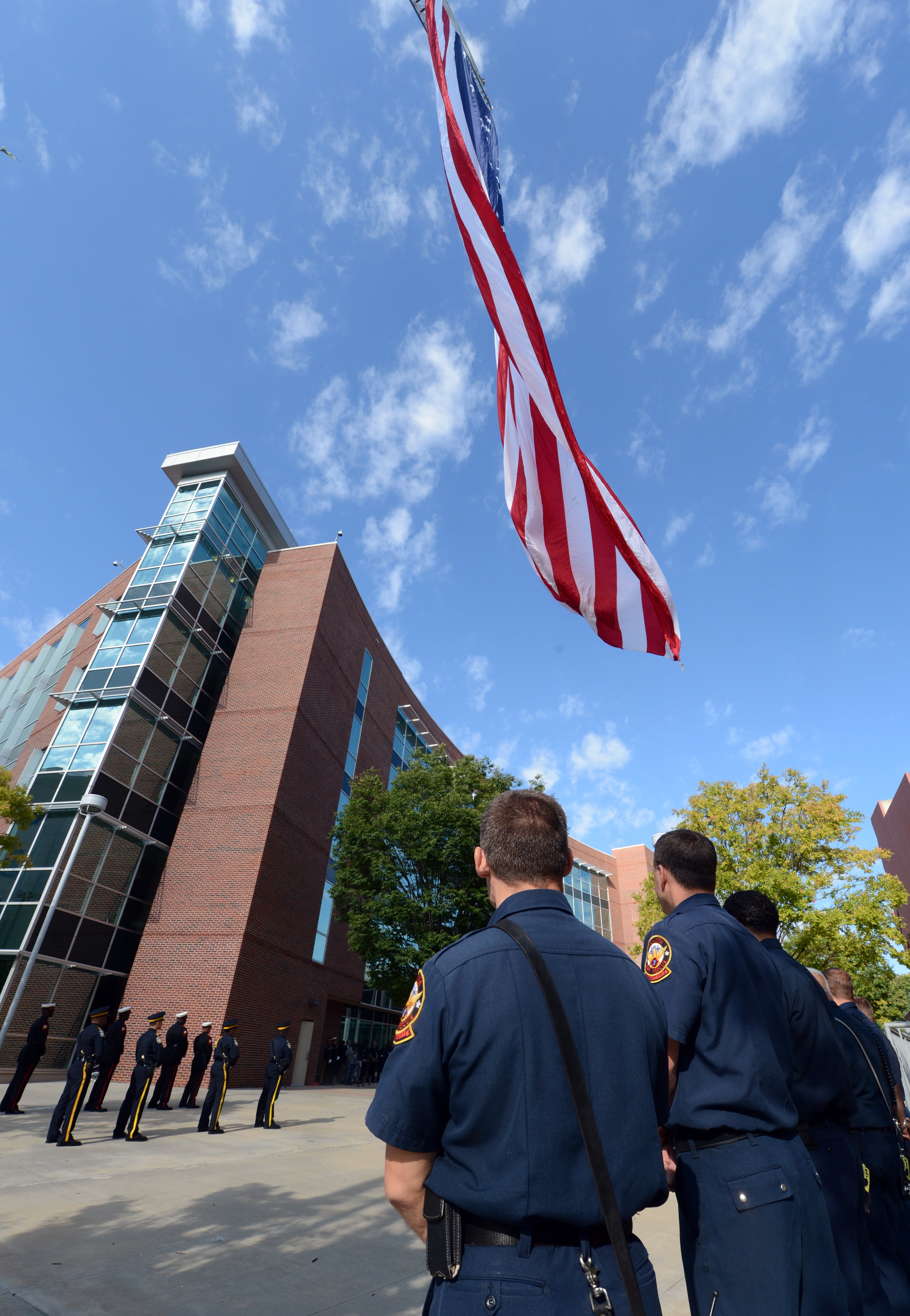 A 50-foot American flag flies from the raised ladder of Truck 1 during a ceremony at the Public Safety Headquarters in Atlanta.