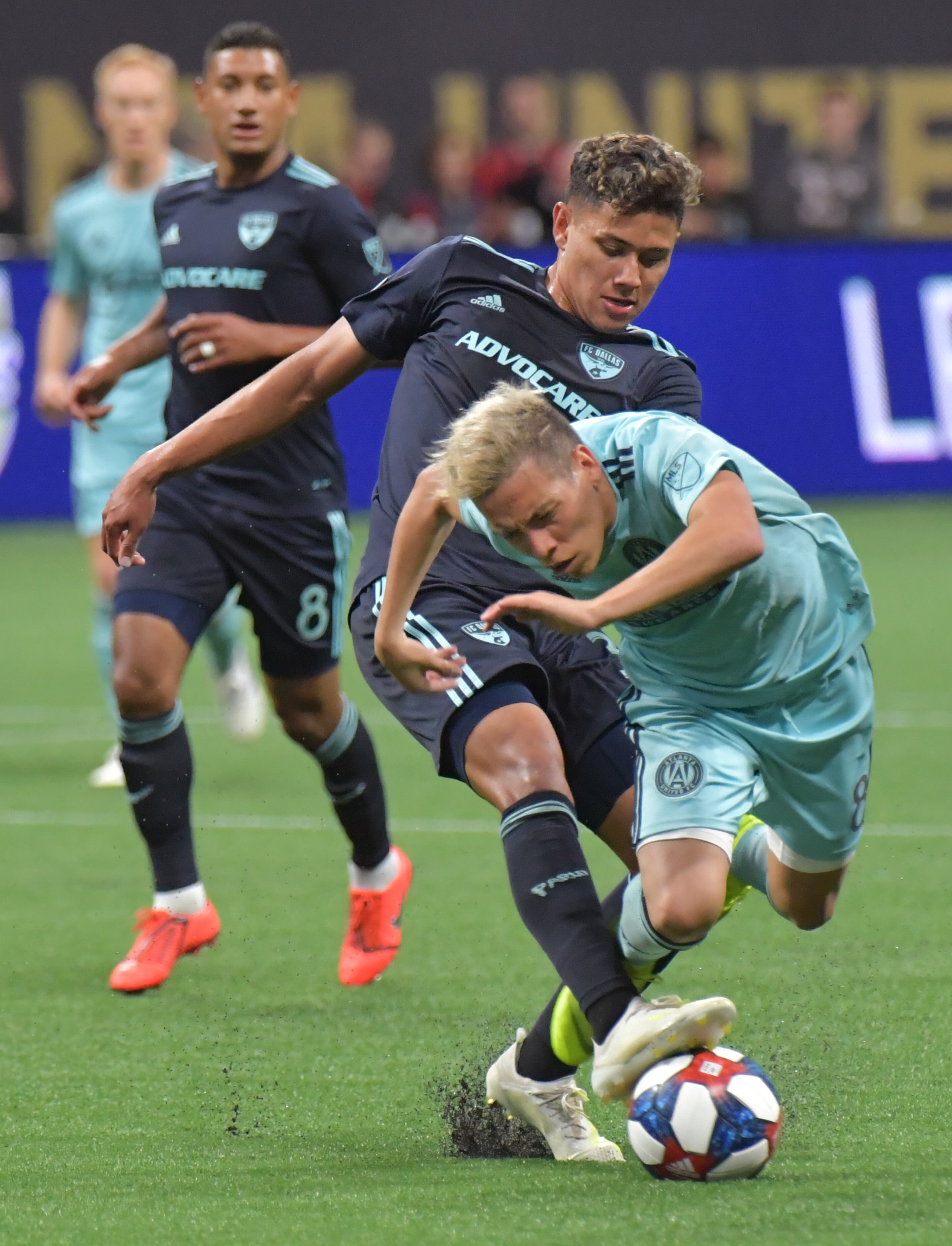 April 20, 2019 Atlanta - FC Dallas midfielder Edwin Cerrillo (33) and Atlanta United midfielder Ezequiel Barco (8) battle for the ball during the second half in a MLS soccer match at Mercedes-Benz Stadium in Atlanta on Saturday, April 20, 2019. FC Dallas won 2-1 over the Atlanta United. HYOSUB SHIN / HSHIN@AJC.COM