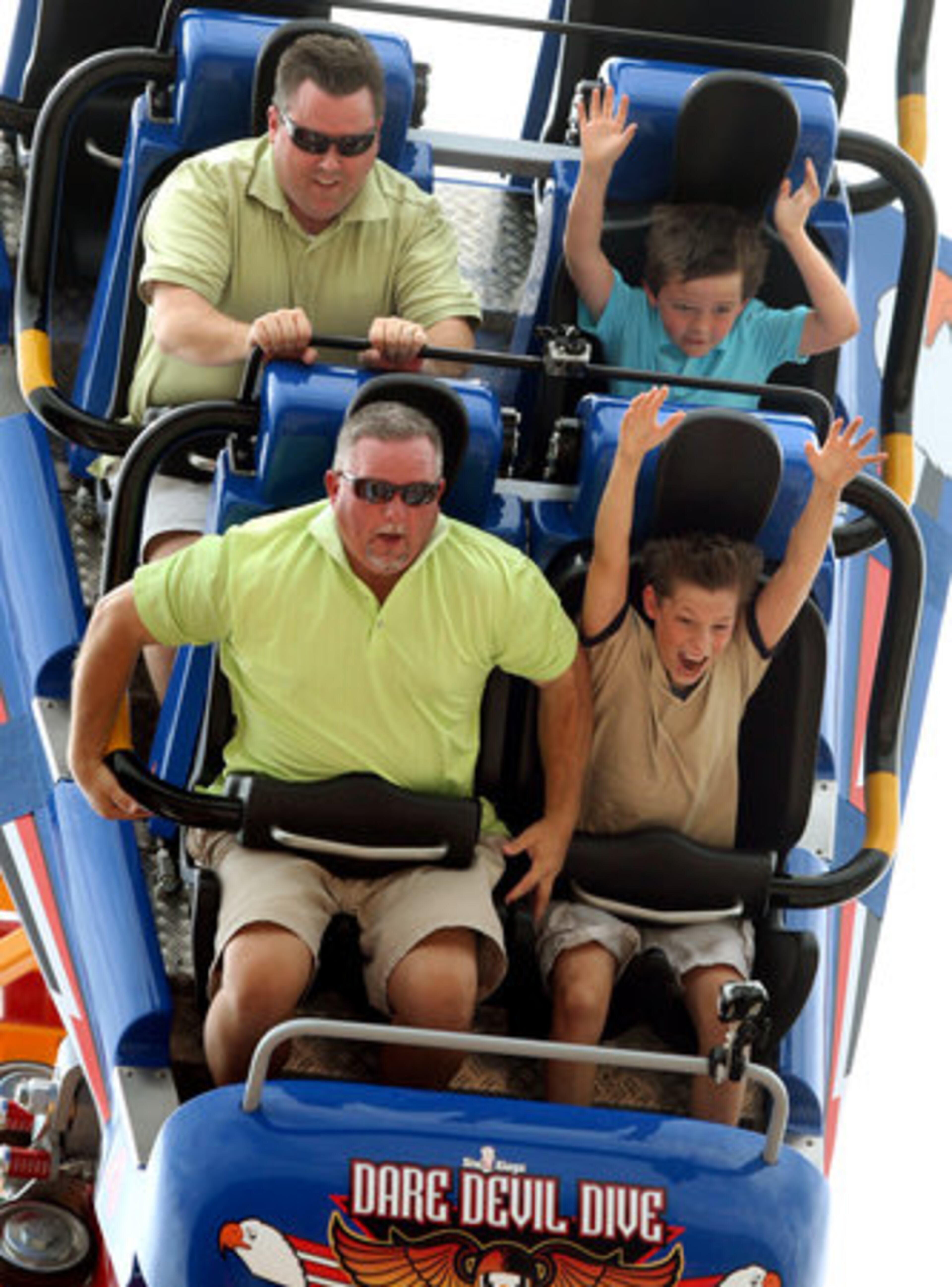 Neighbors from Newnan, Tim Clayton, bottom left, and his son Liam, 11, bottom right, and Kevin Smallhorn, top left, and his son Charlie, 7, react as they take the initial 10-story drop to start their ride on the Dare Devil Dive at Six Flags Over Georgia in Austell May 26, 2011. The two-minute ride reaches a top speed of 52 mph and spans 2,005 feet of track. It officially opens to the public May 28, 2011.