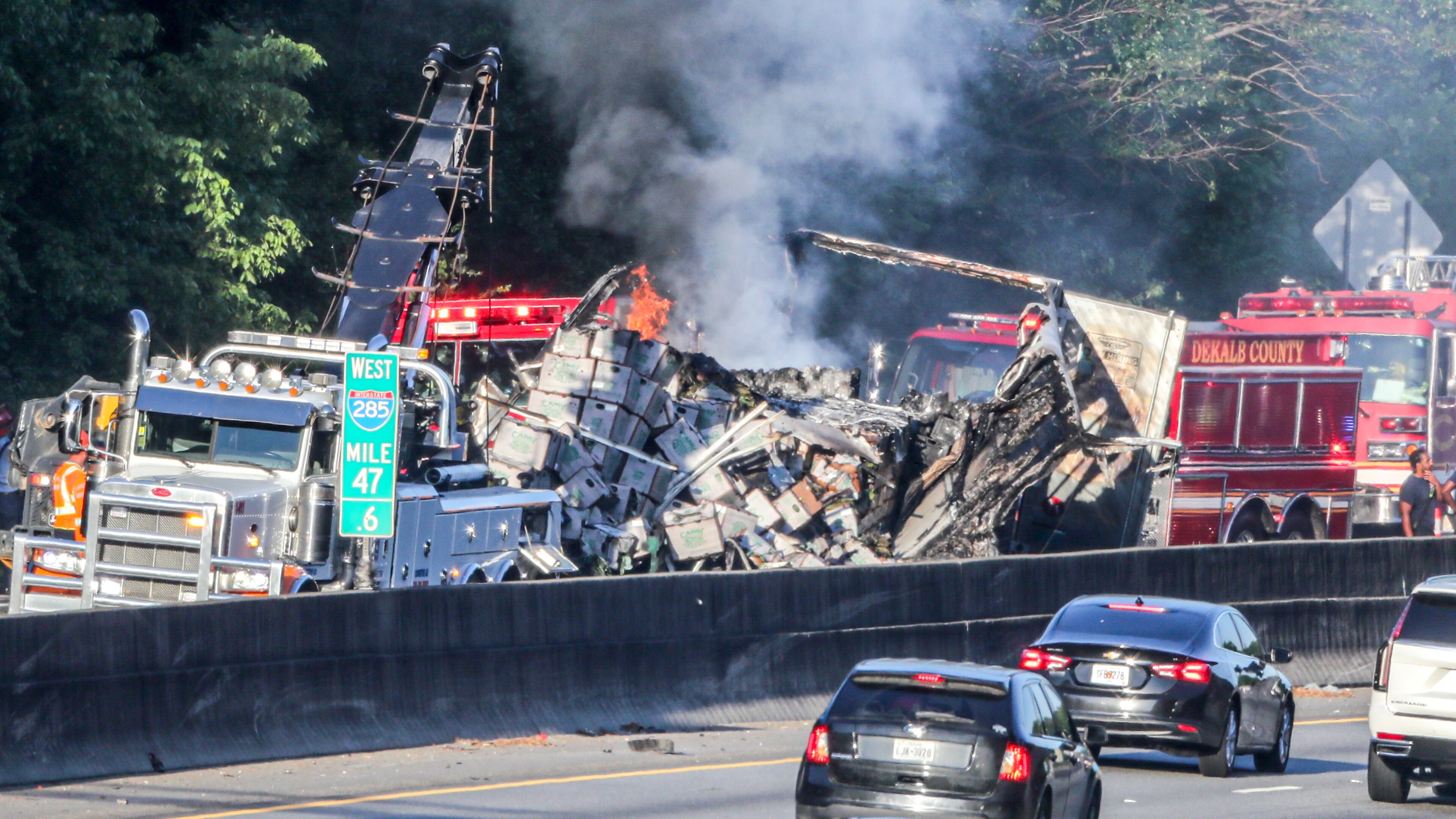 June 20, 2022 Dekalb County: Two predawn crashes made a mess of things Monday, June 20, 2022 on I-285 in DeKalb County, shutting down both the inner and outer loops for hours during the morning commute. Two eastbound lanes of I-285 at Flat Shoals Parkway remained closed at 9:30 a.m., according to the WSB 24-hour Traffic Center. All lanes were closed around 4:45 a.m., when the big rig was involved in a multivehicle wreck and burst into flames. According to DeKalb police, the tractor-trailer’s brakes went out and it hit two unoccupied, abandoned vehicles after pulling into an emergency lane. One of the empty vehicles also caught fire, but no one was injured, a police spokesperson said. The flames have since been extinguished, but a crash investigation is ongoing. On the inner loop, traffic was backed up for miles behind another wreck at Glenwood Road. A pedestrian was hit and killed, and the driver involved stayed at the scene, police said. All southbound lanes were closed at 5:30 a.m. and started reopening two hours later. (John Spink / John.Spink@ajc.com)