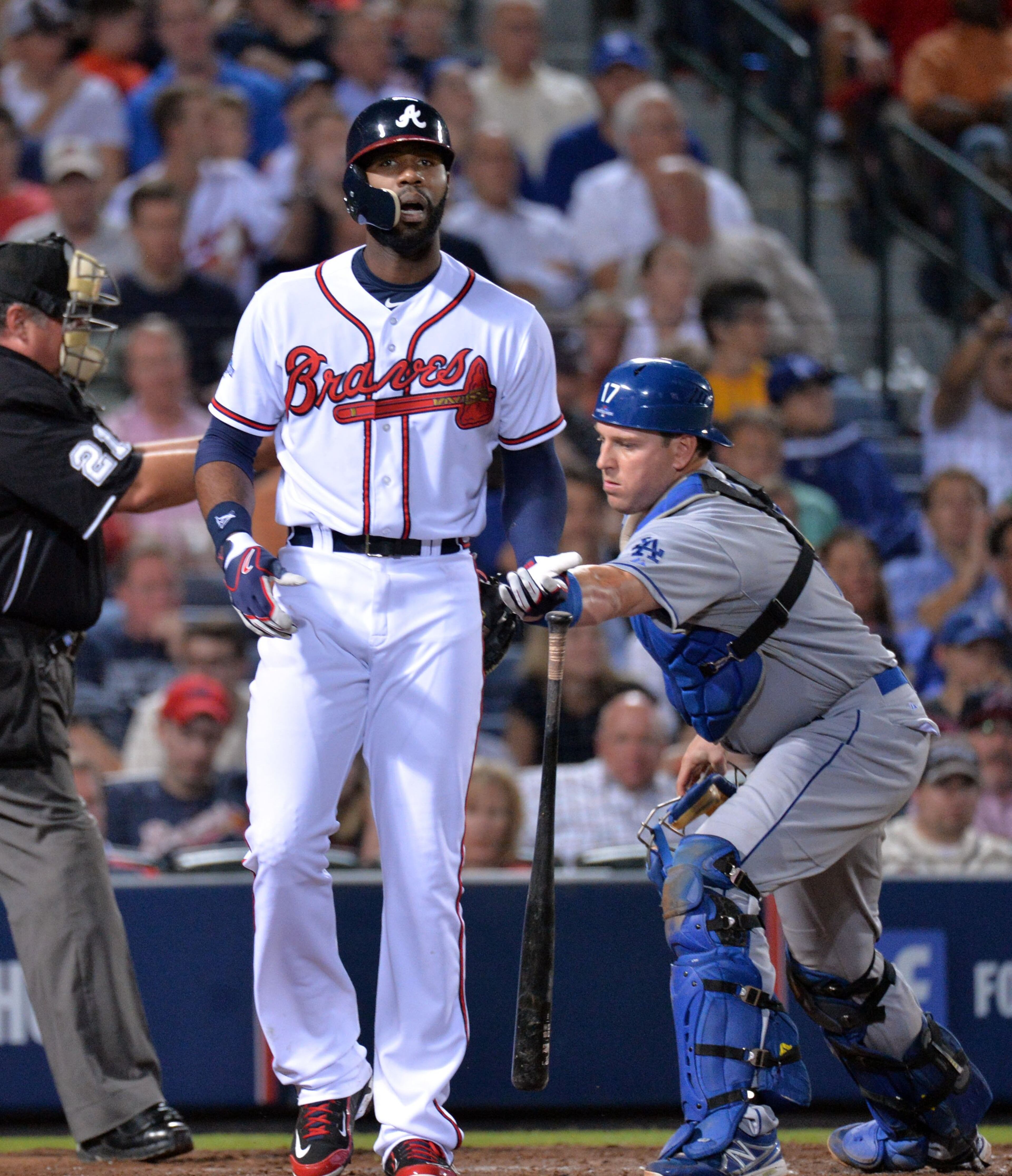 Atlanta Braves right fielder Jason Heyward (22) is tagged by Los Angeles Dodgers catcher A.J. Ellis (17) after third strike in the 5th inning during the first game of the National League Division series between the Los Angeles Dodgers and Atlanta Braves at Turner Field, Thursday, October 3, 2013.