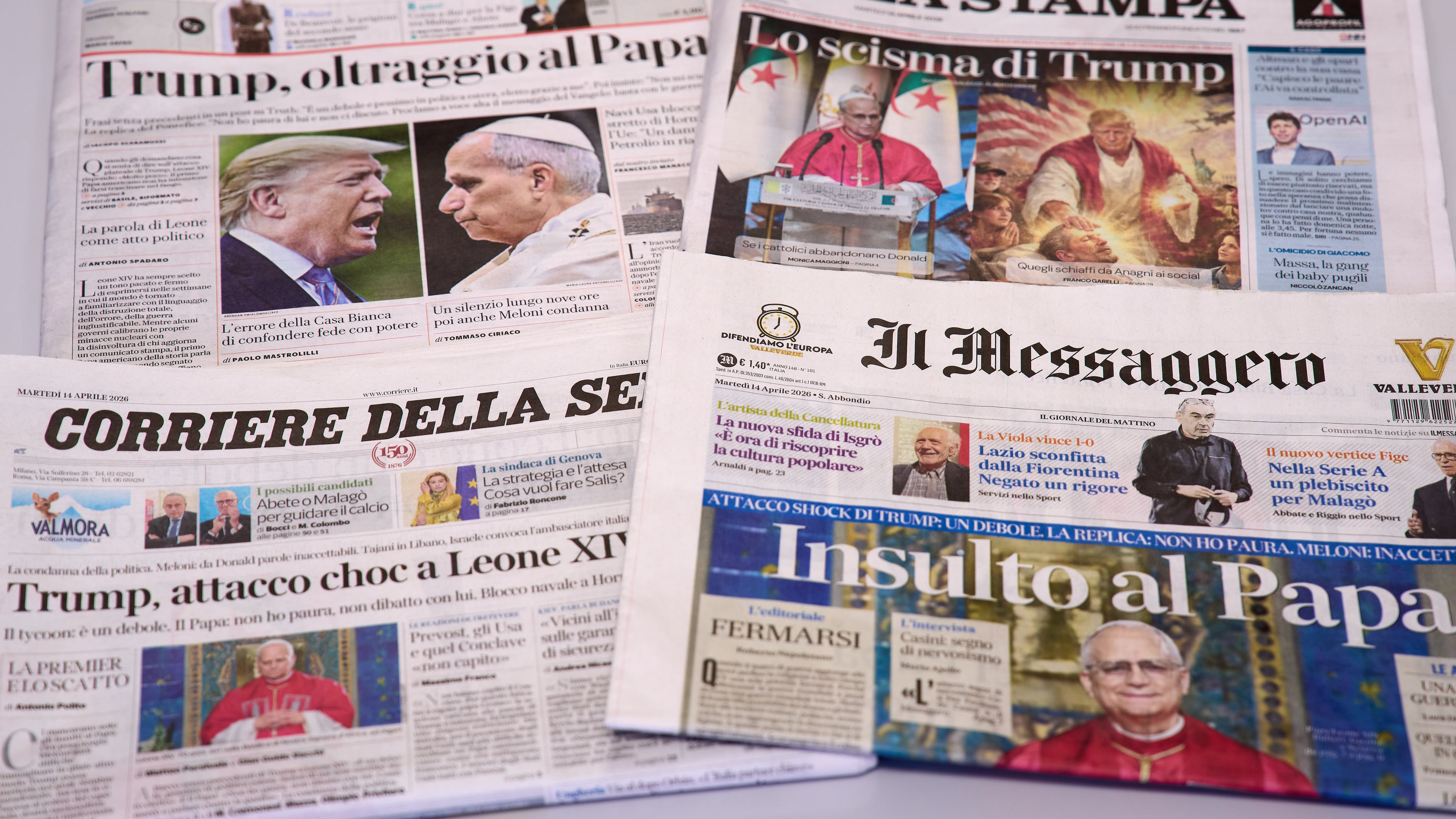This picture, taken Tuesday, April 14, 2026, shows the front pages of some Italian newspapers reporting on comments by U.S. President Donald Trump about Pope Leo XIV, with headlines using words such as "outrage", "shock attack", "insult", and Trump's schism". (AP Photo/Domenico Stinellis)