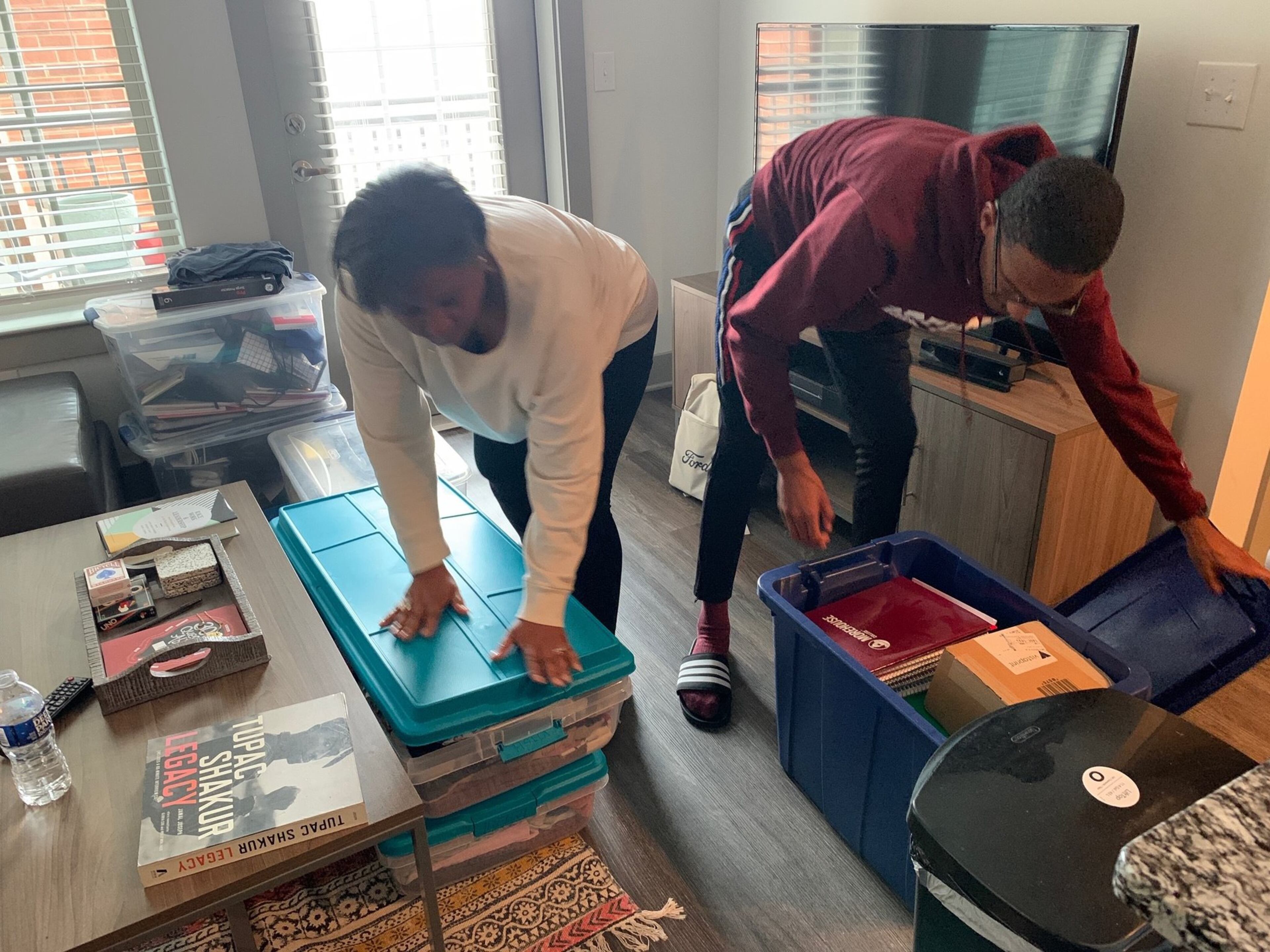 Morehouse College senior John Bowers (right) and his mother, Rhetta Andrews Bowers, a state representative from Dallas, Texas, pack up his belongings from his off-campus apartment on Tuesday, March 17, 2020. Bowers, Morehouse’s student government association president, has been helping students who need temporary housing and other resources as Morehouse and other colleges close their campuses in response to the coronavirus outbreak.