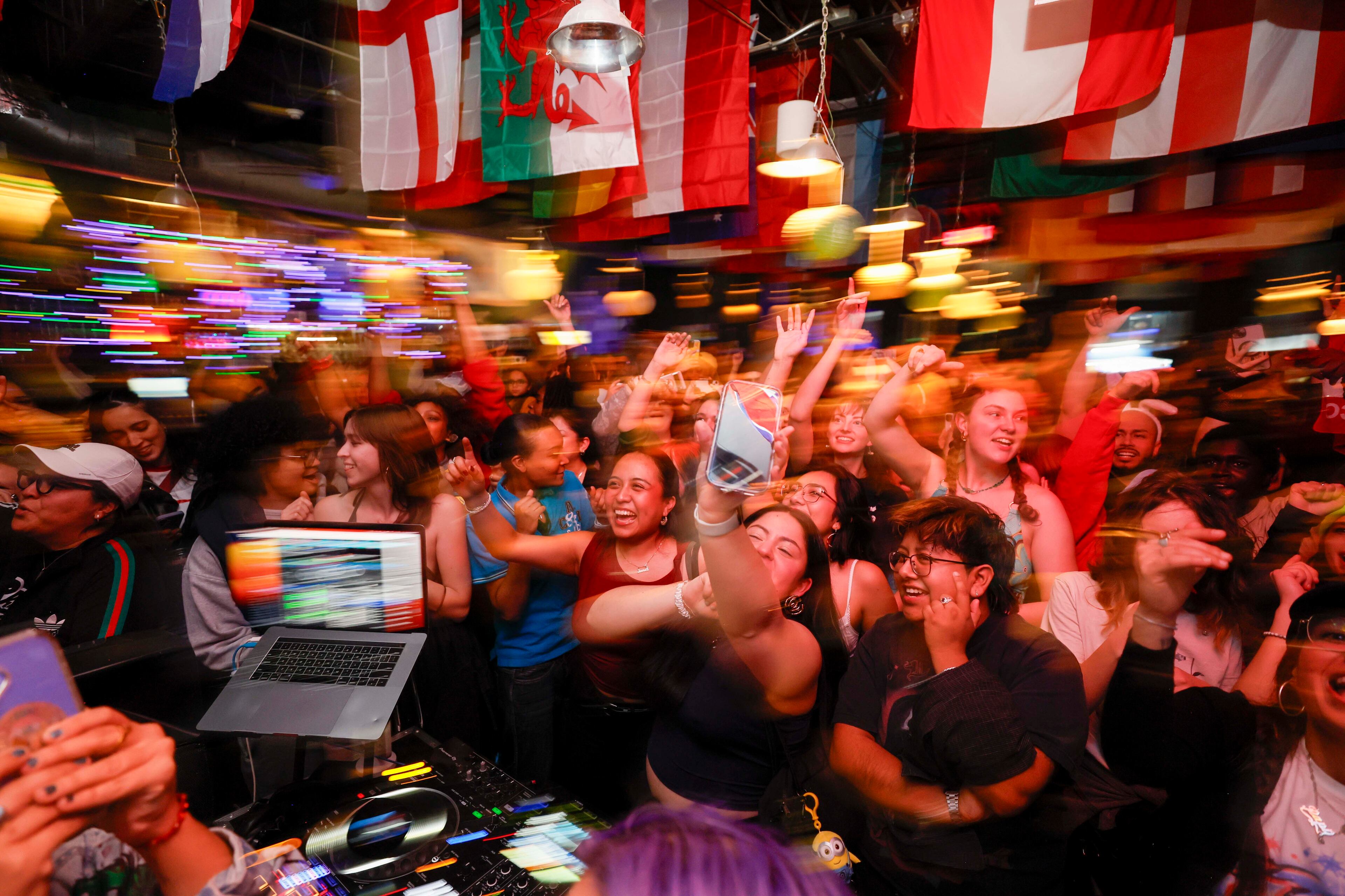 Attendees react as they watch the start of the Bad Bunny Super Bowl halftime show during a watch party and fundraiser for Casa Alterna at Thinking Man Tavern in Decatur on Sunday, Feb. 8, 2026. (Miguel Martinez/AJC)