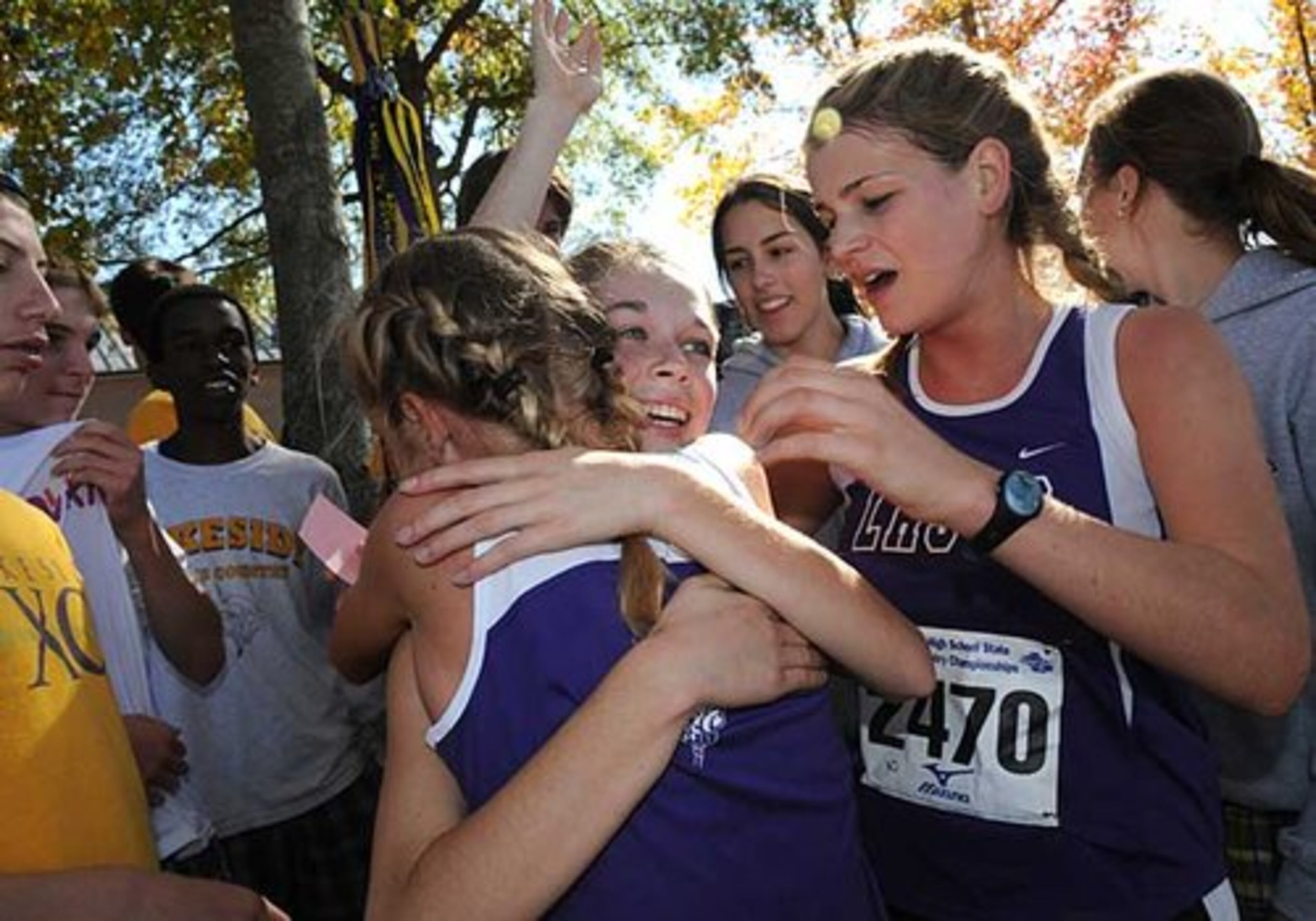Lakeside's Meghan Wetterhall is congratulated by teammates after her first-place finish.