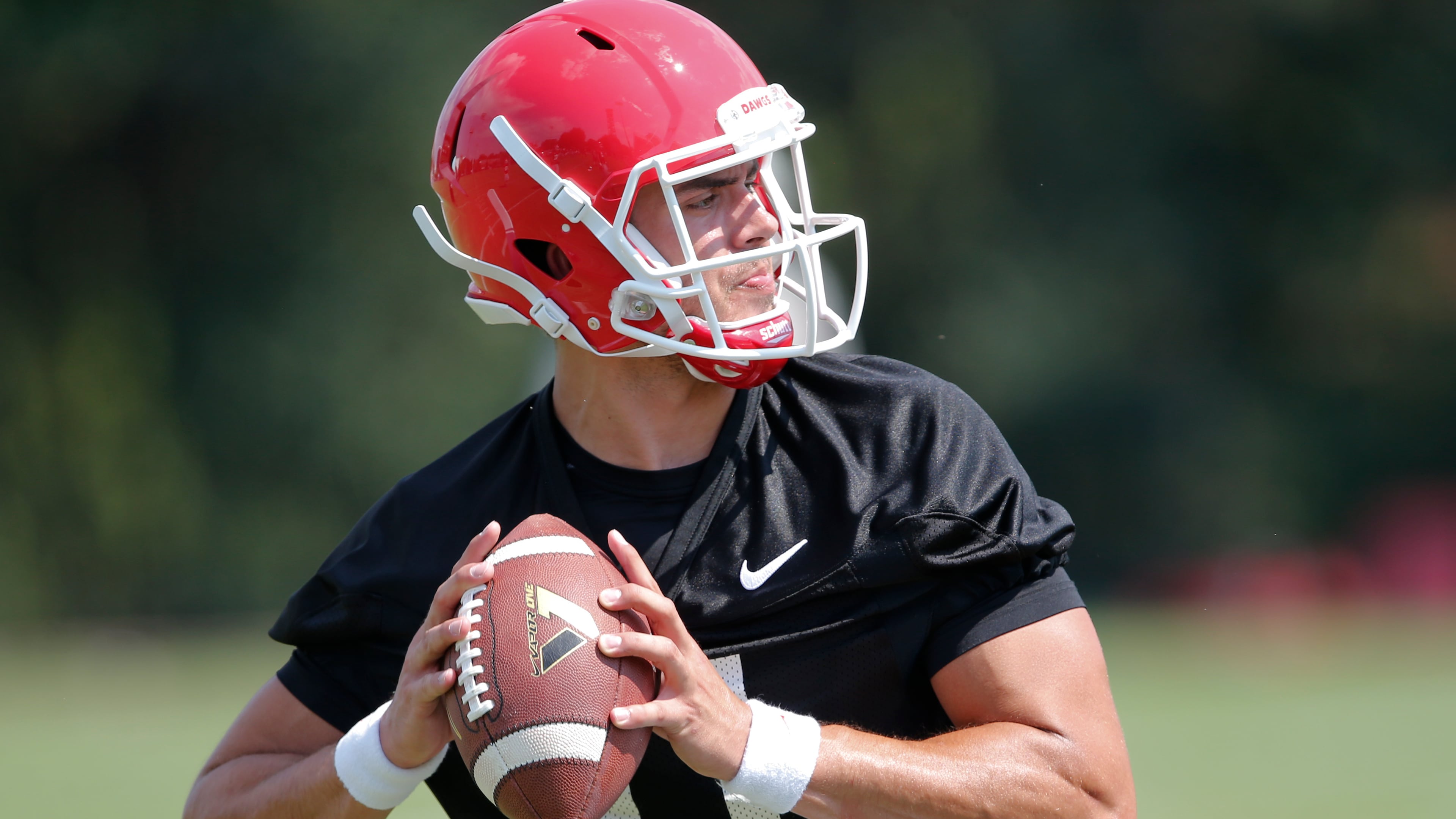 FILE - This Aug. 4, 2015, file photo, shows Georgia quarterback Greyson Lambert during a college football practice in Athens, Ga. One year ago, Greyson Lambert was on his way to starting nine games at Virginia. Now, as a graduate transfer, he is the newly named starting quarterback for No. 9 Georgia _ a fresh beginning that comes with heavy expectations. (AP Photo/John Bazemore, File)