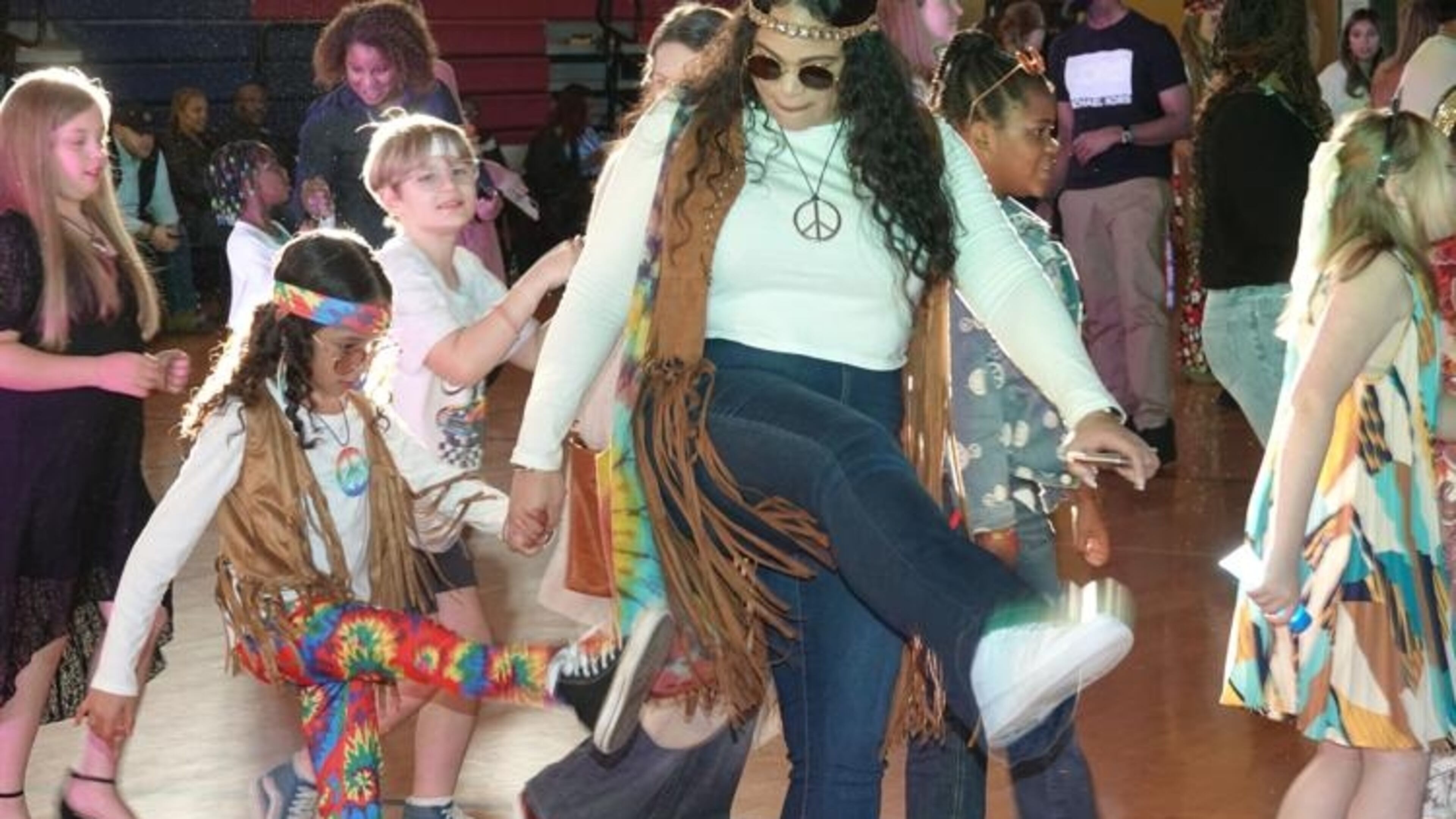 Ava and Andrea Sanders dance the night away in their colorful, groovy outfits. (Photo Courtesy of Majid Bassery)