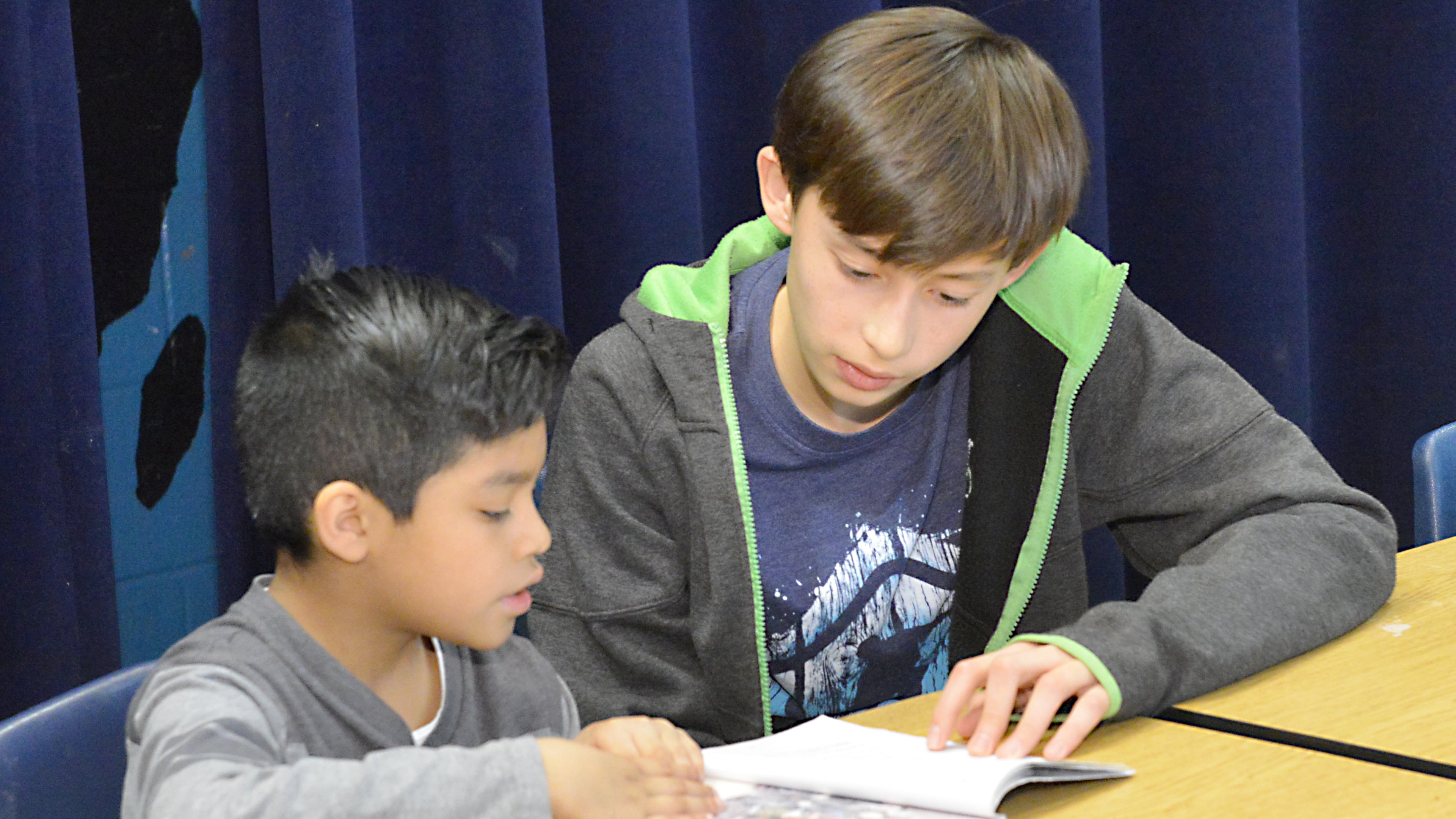 High Meadows student Lucas Patsy (right) works with a youngster in the Star House after-school support program at Mimosa Elementary in Roswell. Eighth graders from High Meadows have been working as peer tutors for four years.