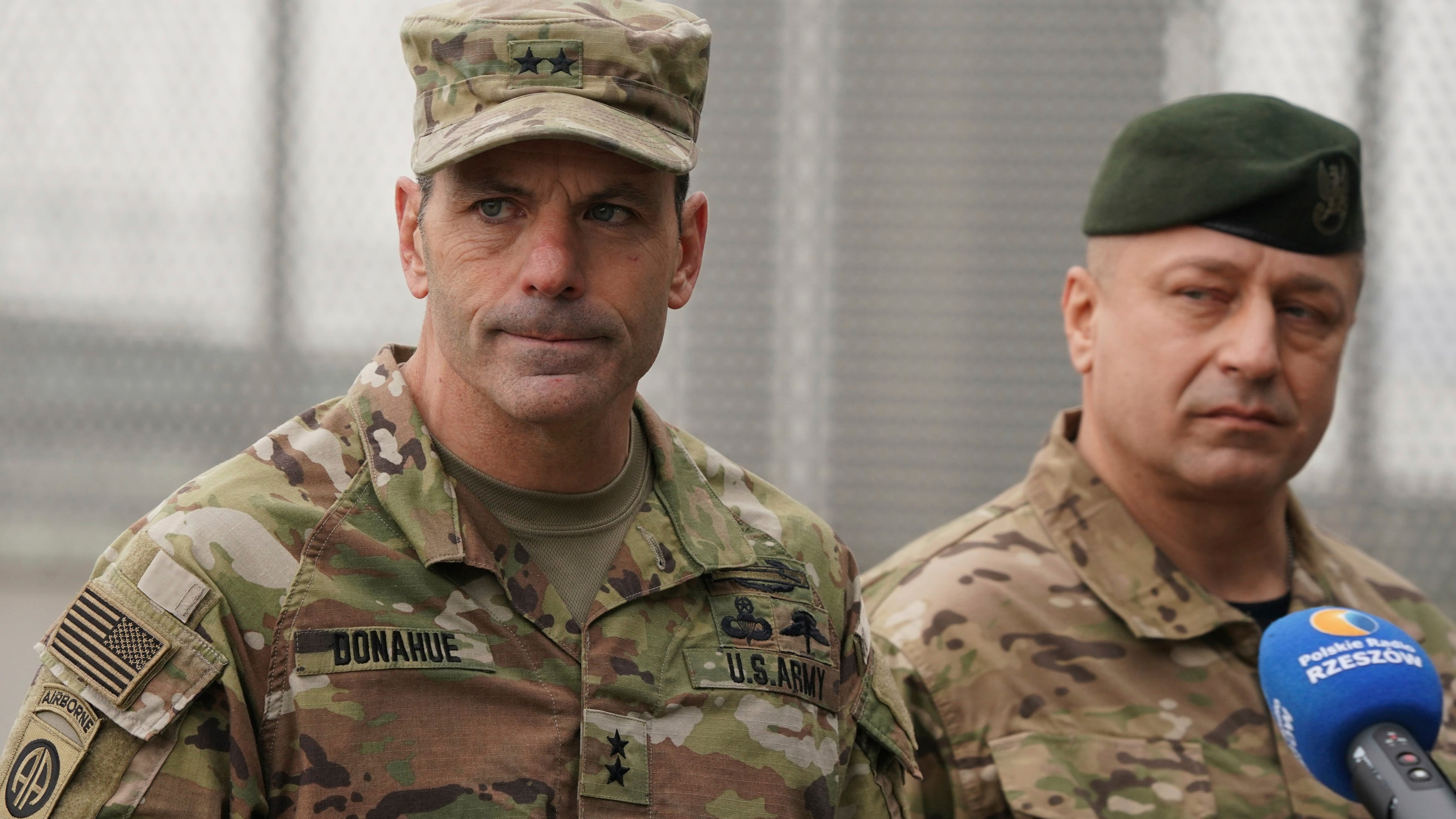 FILE - U.S. Army General Christopher Donahue, left, commanding general of the 82nd Airborne Division, and Polish General Wojciech Marchwica speak to journalists after unloading vehicles from a transport plane arriving from Fort Bragg at the Rzeszow-Jasionka airport in southeastern Poland, on Feb. 6, 2022. (AP Photo, File)