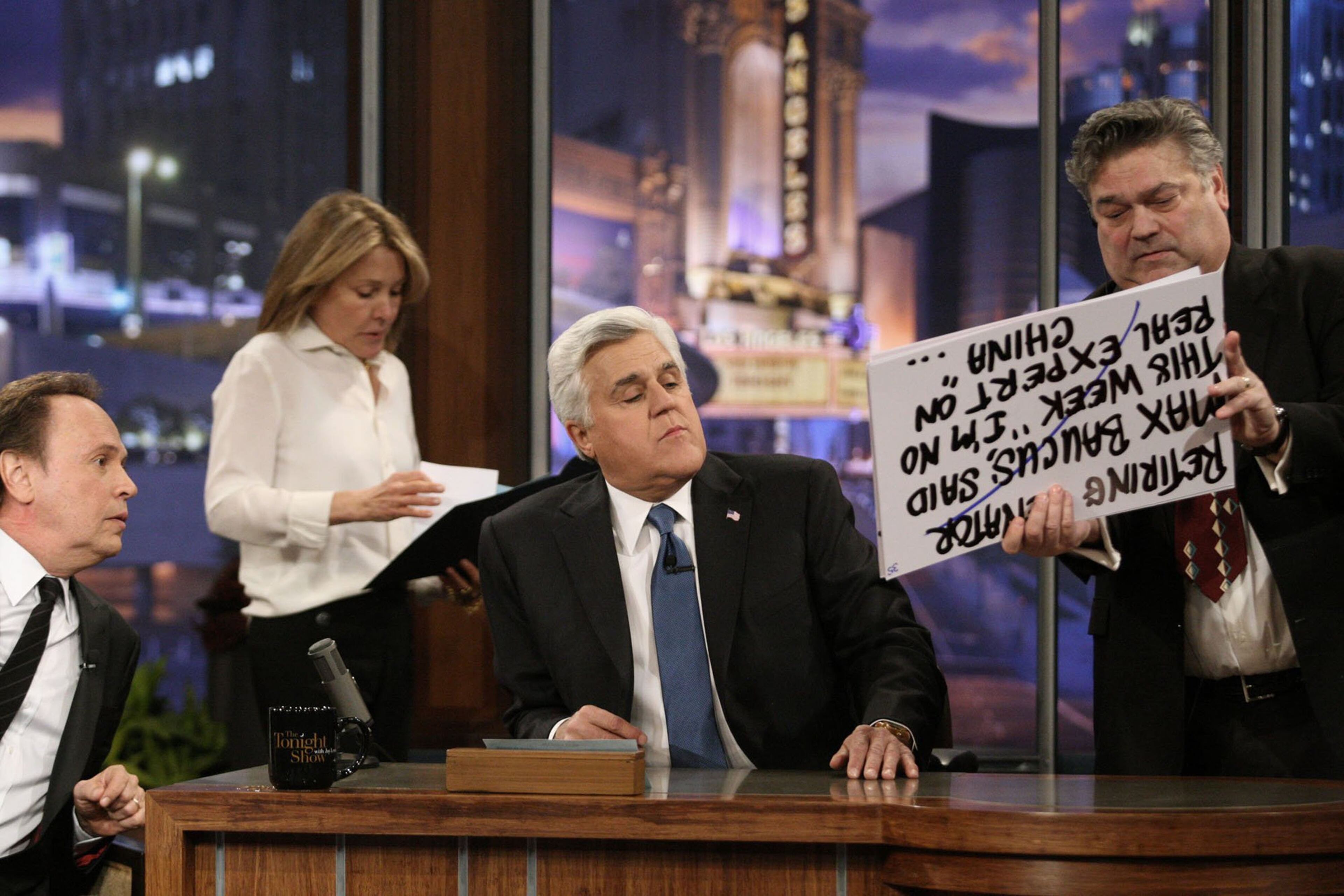 Jay Leno, second from right, looks at cue cards with guest Billy Crystal, left, during a commercial break for Leno's final show as host of "The Tonight Show" on Thursday, Feb. 6, 2014, in Burbank, Calif. (Gary Friedman/Los Angeles Times/MCT)