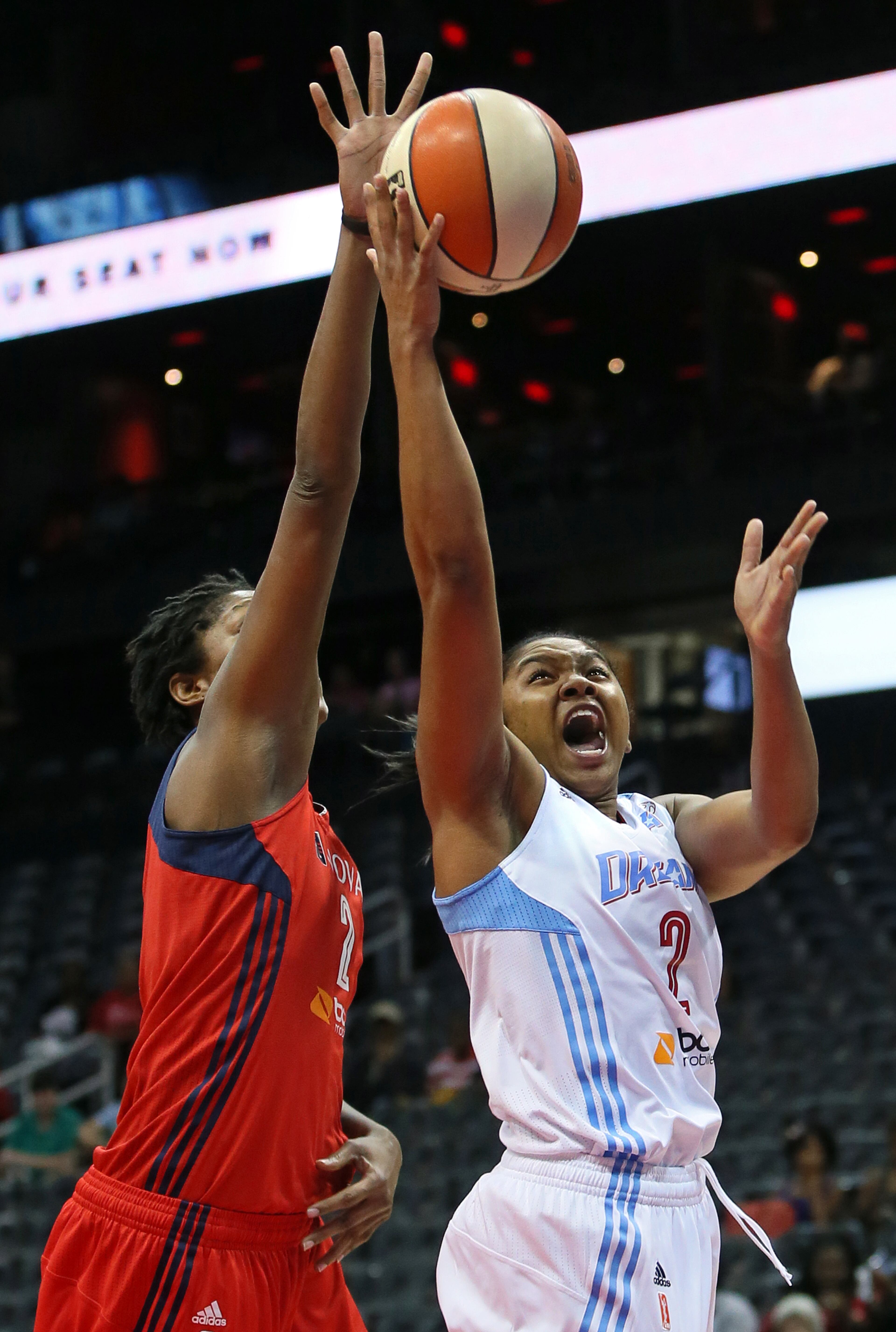 Dream guard Alex Bentley battles Mystics center Michelle Snow driving to the basket during the first half of their WNBA playoff game on Thursday, Sept. 19, 2013, in Atlanta.