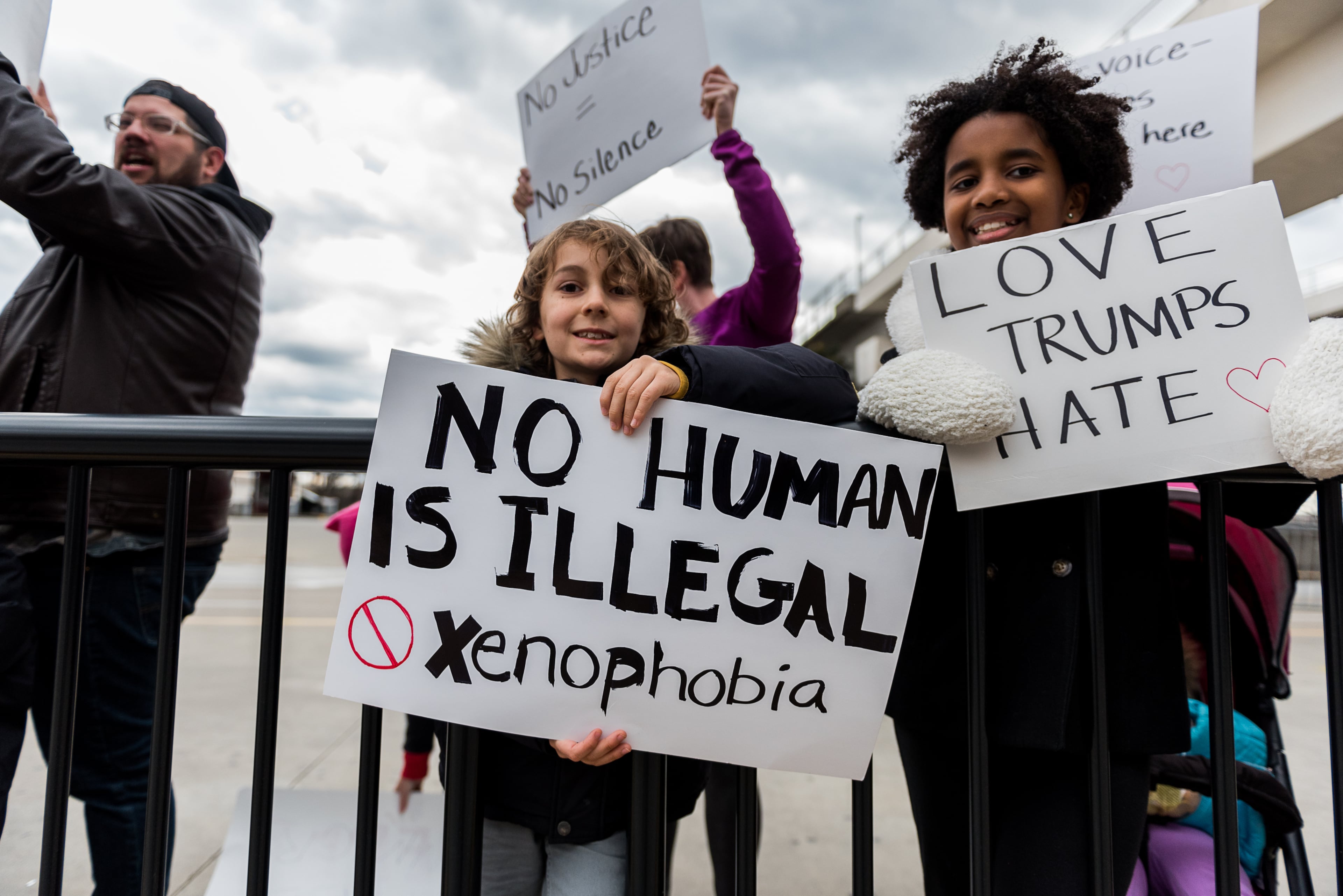 A child holds a sign in protest of President Donald J. Trump's recent executive order, Sunday, January 29, 2017. (Cory Hancock for The AJC)