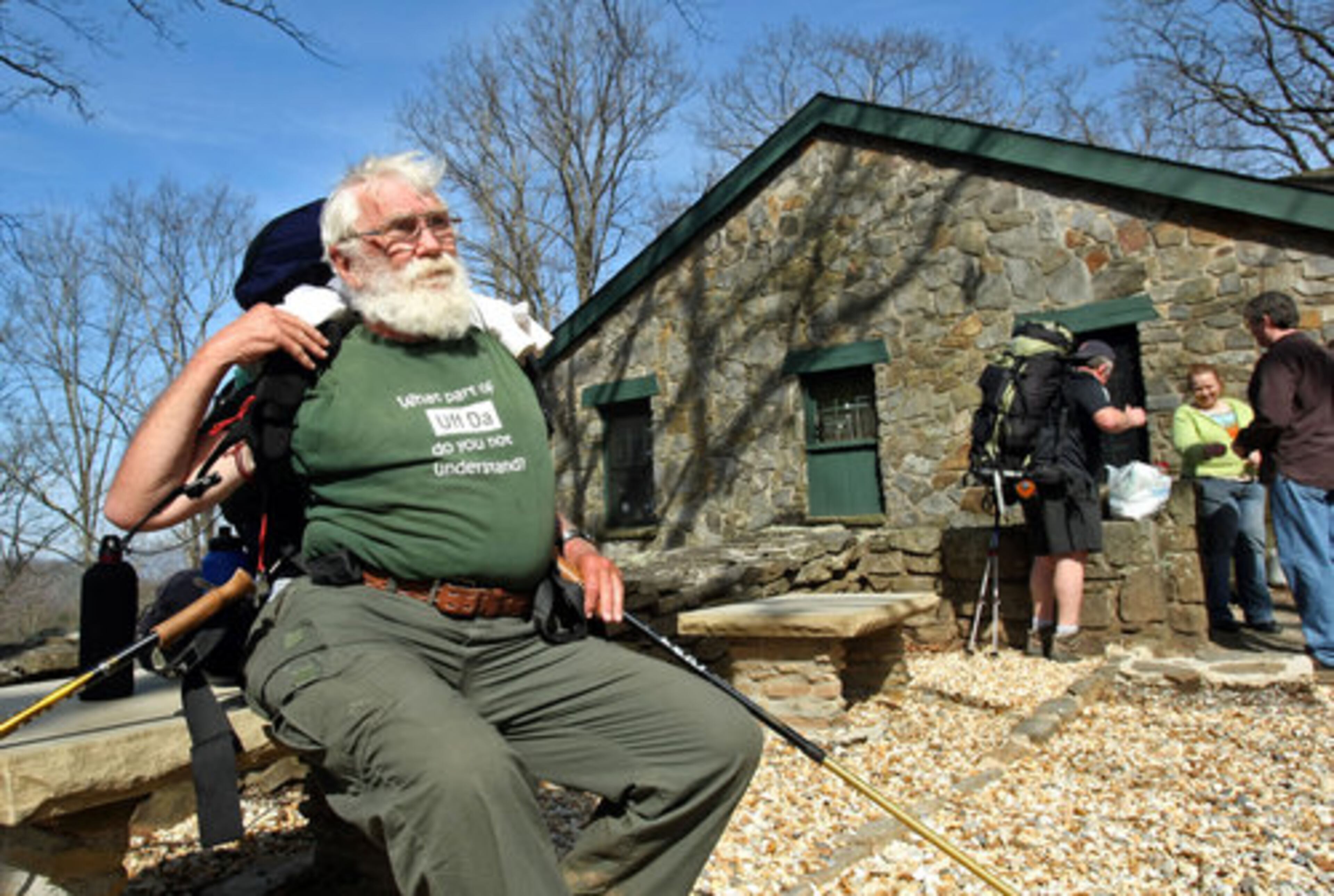 Don "Mom" Johnson, 73, of North Dakota, puts on his backpack as he makes his way to the hostel along the Appalachian Trail at Mountain Crossings at Walasi-Yi.