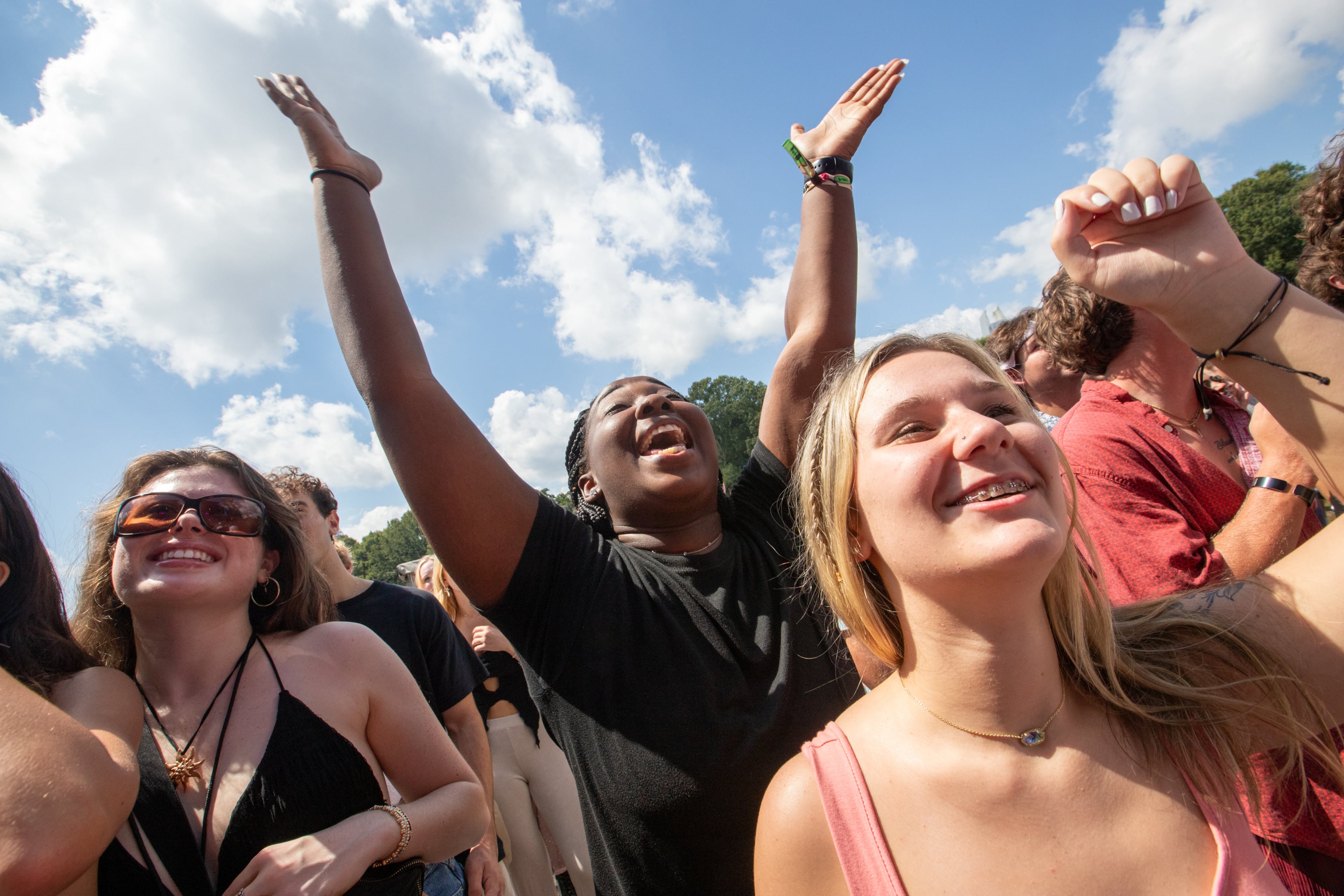 Amari Keith, hands up, left, and Finley Goodwin, right, are at the BigXthaPlug show at Music Midtown in Piedmont Park on Sunday, Sept 17, 2023. (Jenni Girtman for The Atlanta Journal-Constitution)