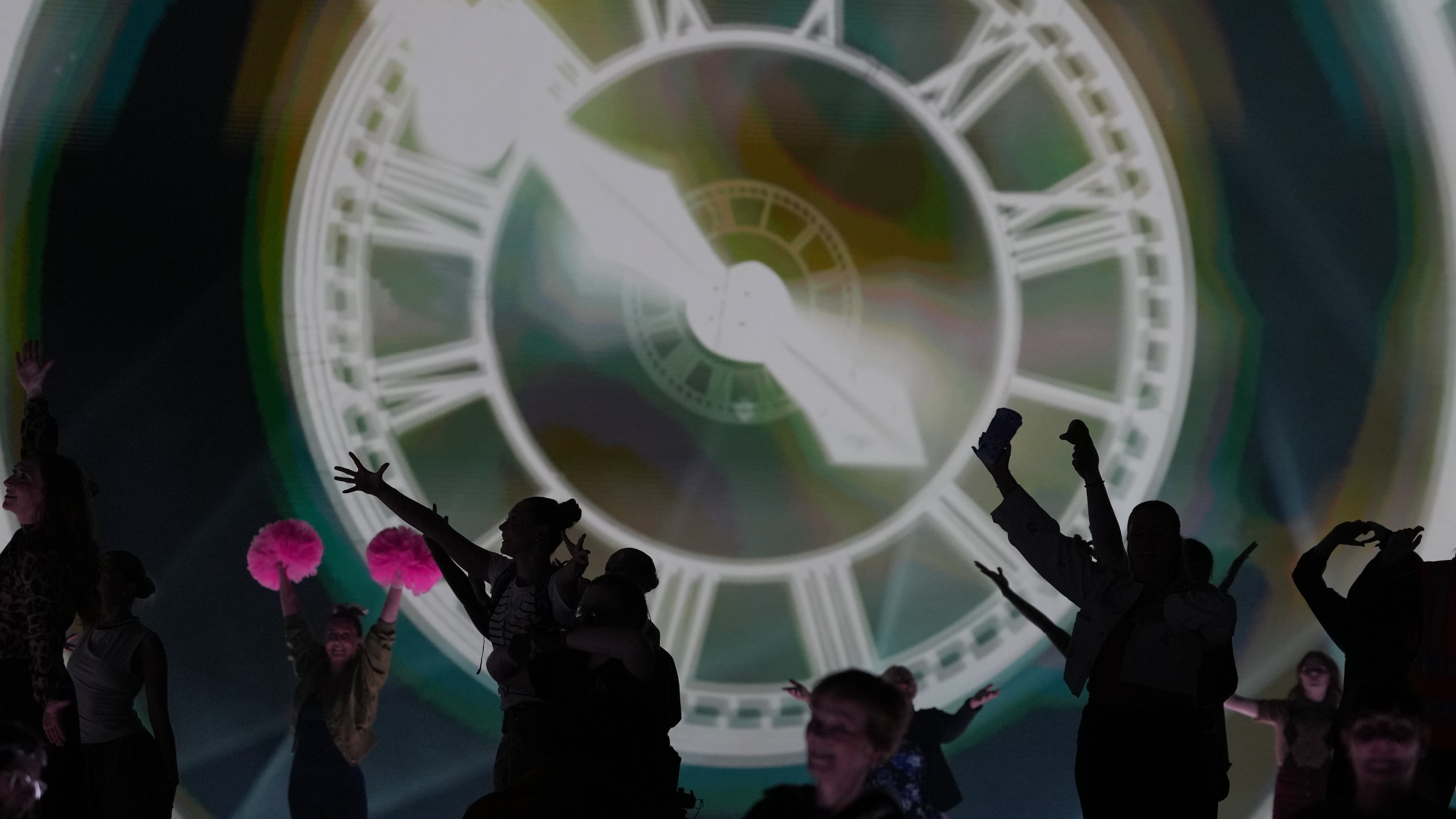 FILE - Performers celebrate the Glasgow Central railway station clock during the Commonwealth Games opening ceremony in Glasgow, Scotland, July 23, 2026. (AP Photo/Kin Cheung, File)