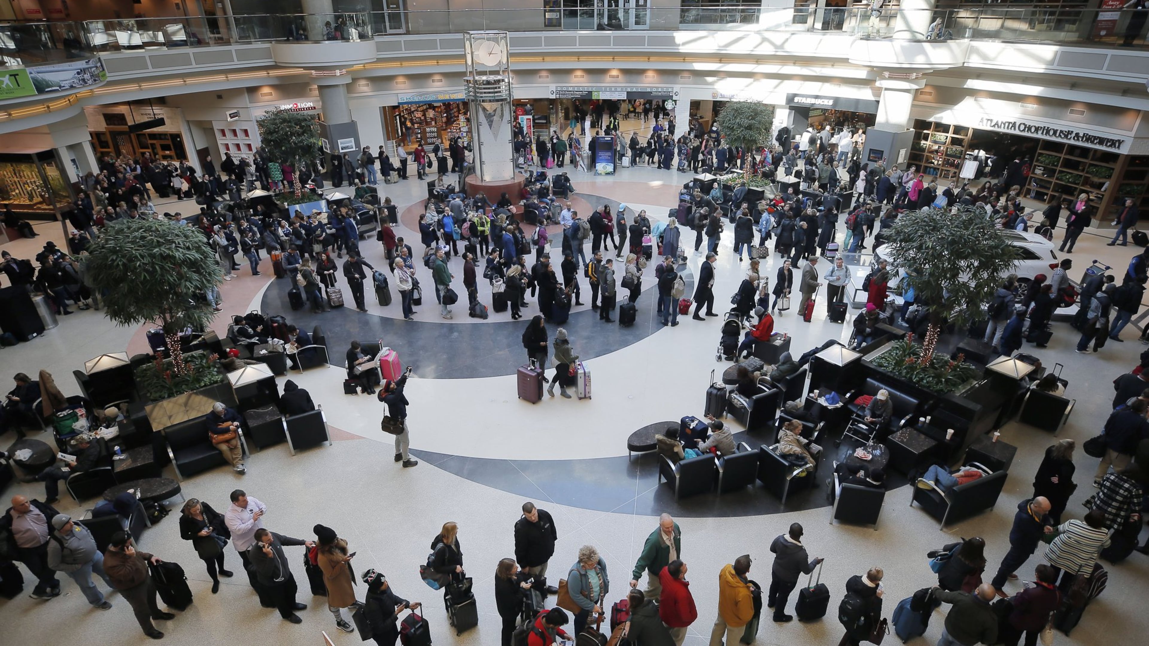 Security lines wrapped through the atrium and around the baggage areas and wait times were more than two hours long at Hartsfield-Jackson International Airport on Wednesday afternoon in the wake of a snowstorm due to a shortage of TSA screeners.BOB ANDRES /BANDRES@AJC.COM