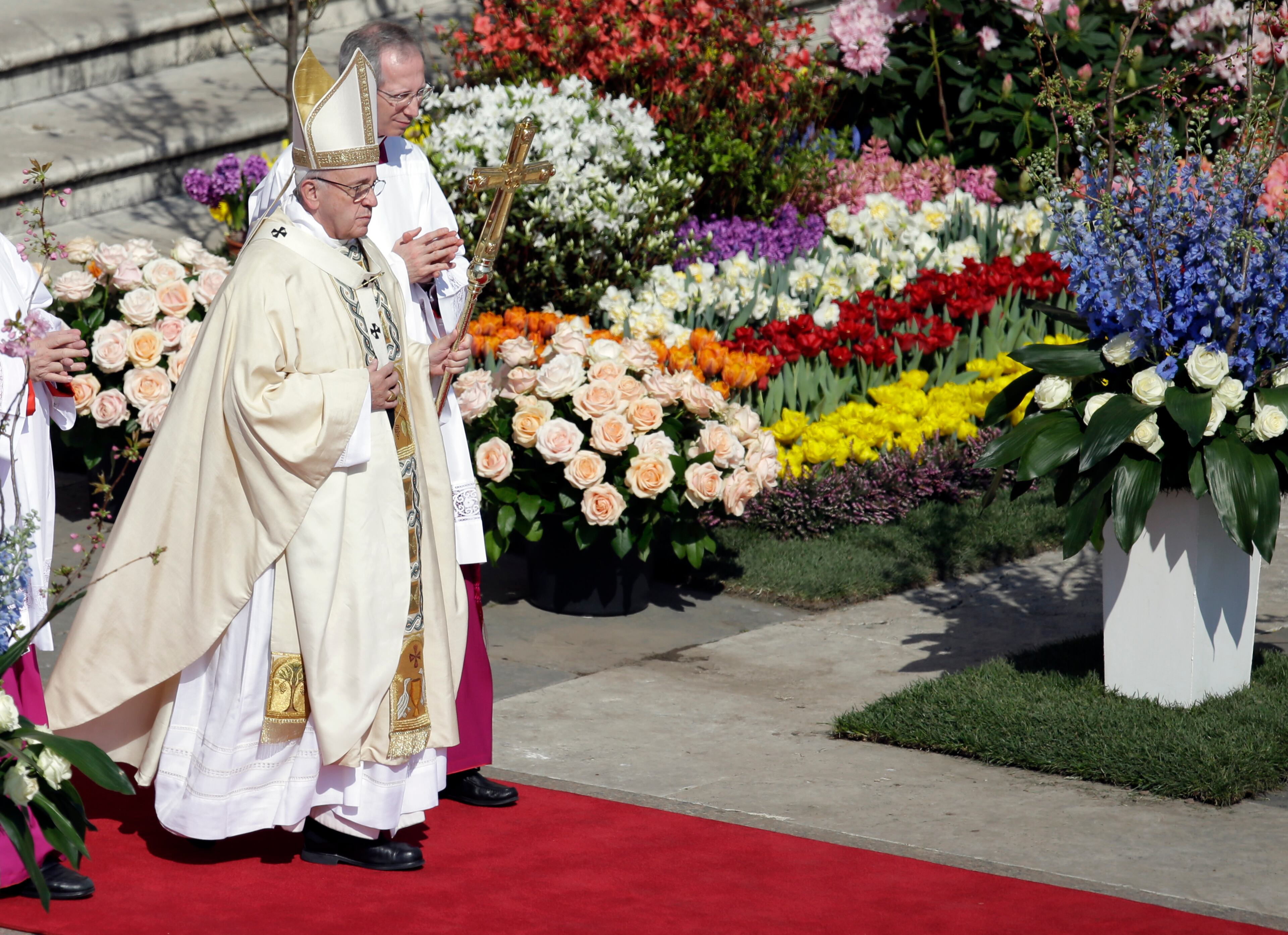 Pope Francis walks with his pastoral staff as he celebrates the Easter mass, in St. Peter's Square, at the Vatican, on March 27, 2016.