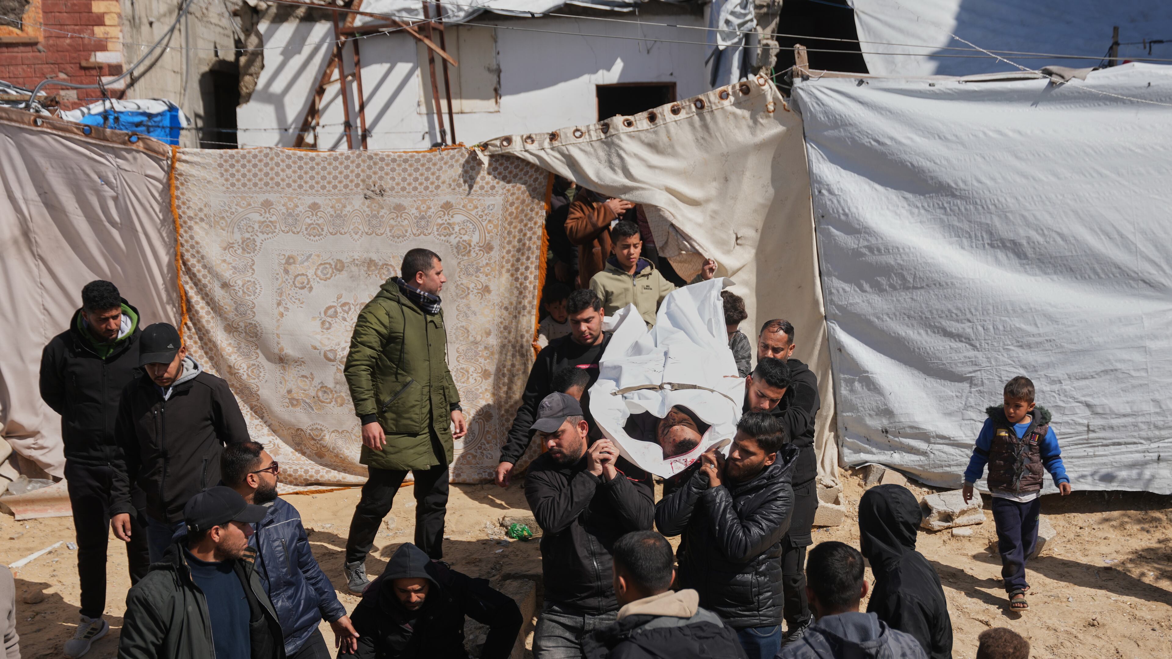 Mourners carry the body of the Palestinian policeman, Khaled Al-Zayan, who was killed in an Israeli military strike, during his funeral in Khan Younis, southern Gaza Strip, Friday, Feb. 27, 2026. (AP Photo/Abdel Kareem Hana)