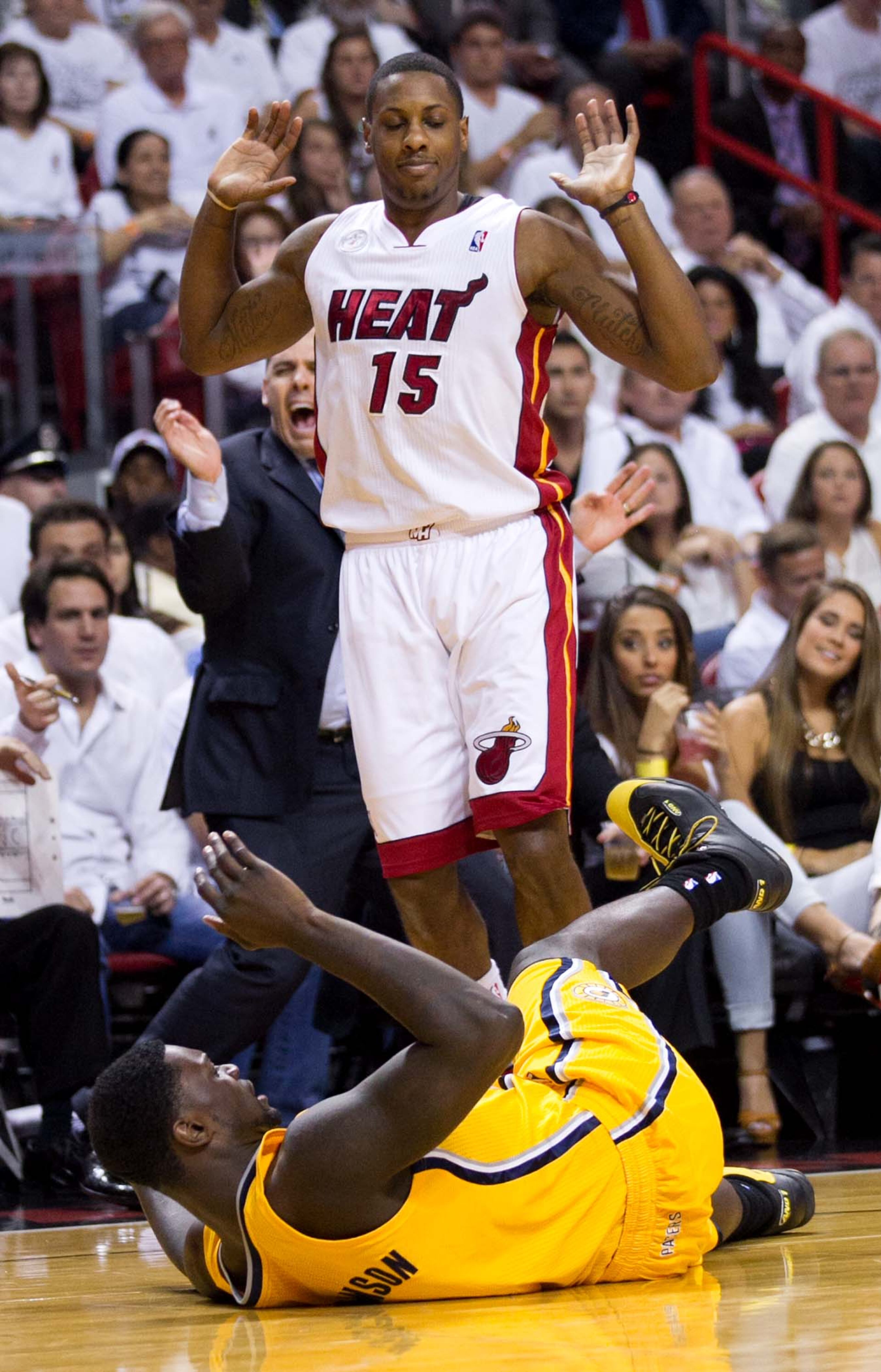 Indiana Pacers shooting guard Lance Stephenson (1) falls to the ground after colliding with Miami Heat point guard Mario Chalmers (15) at AmericanAirlines Arena on June 3, 2013. No foul was called. (Allen Eyestone/The Palm Beach Post)