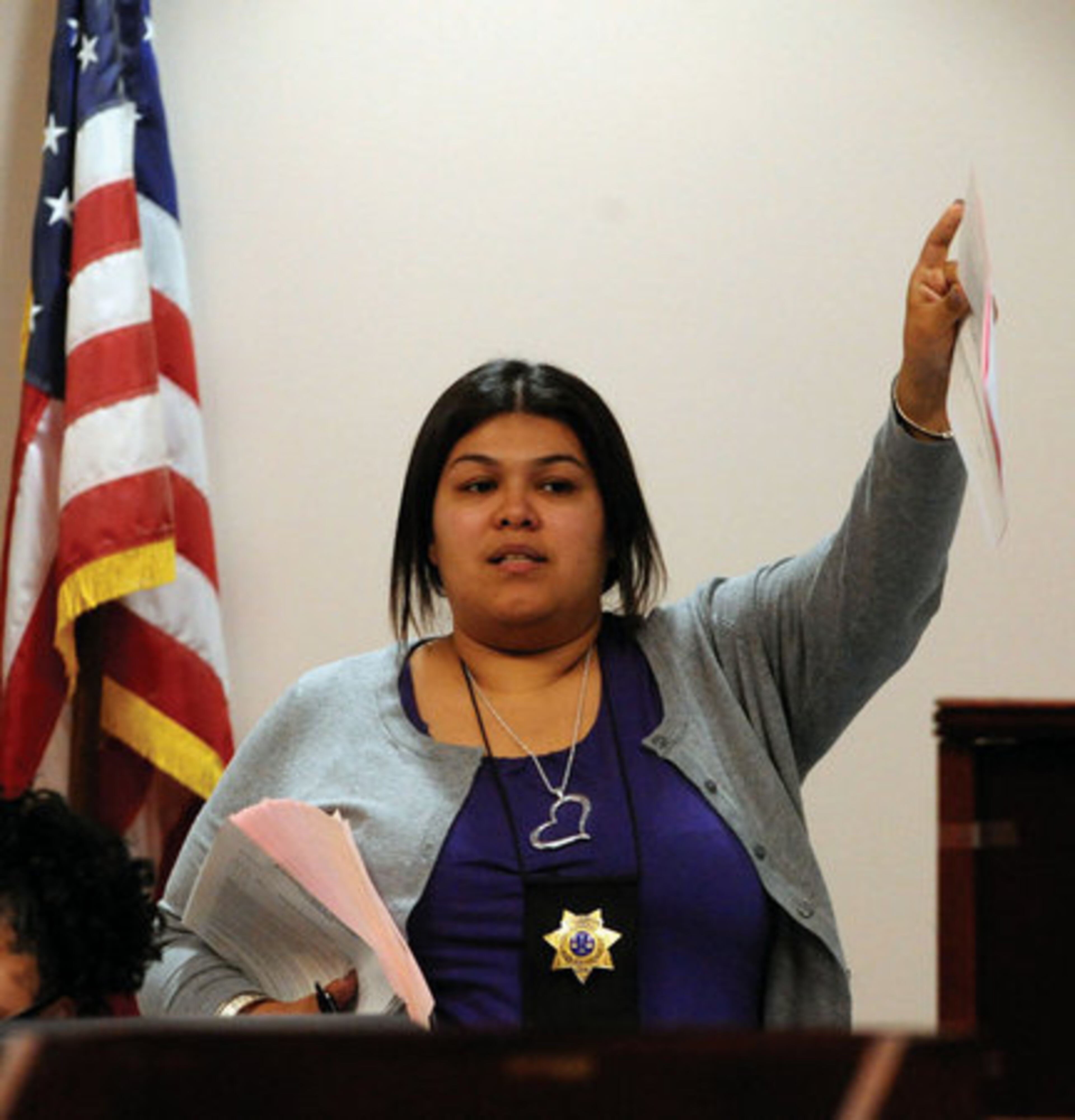Intake Officer Amanda Ozuna makes an announcement in Spanish inside a courtroom in DeKalb Records Court.