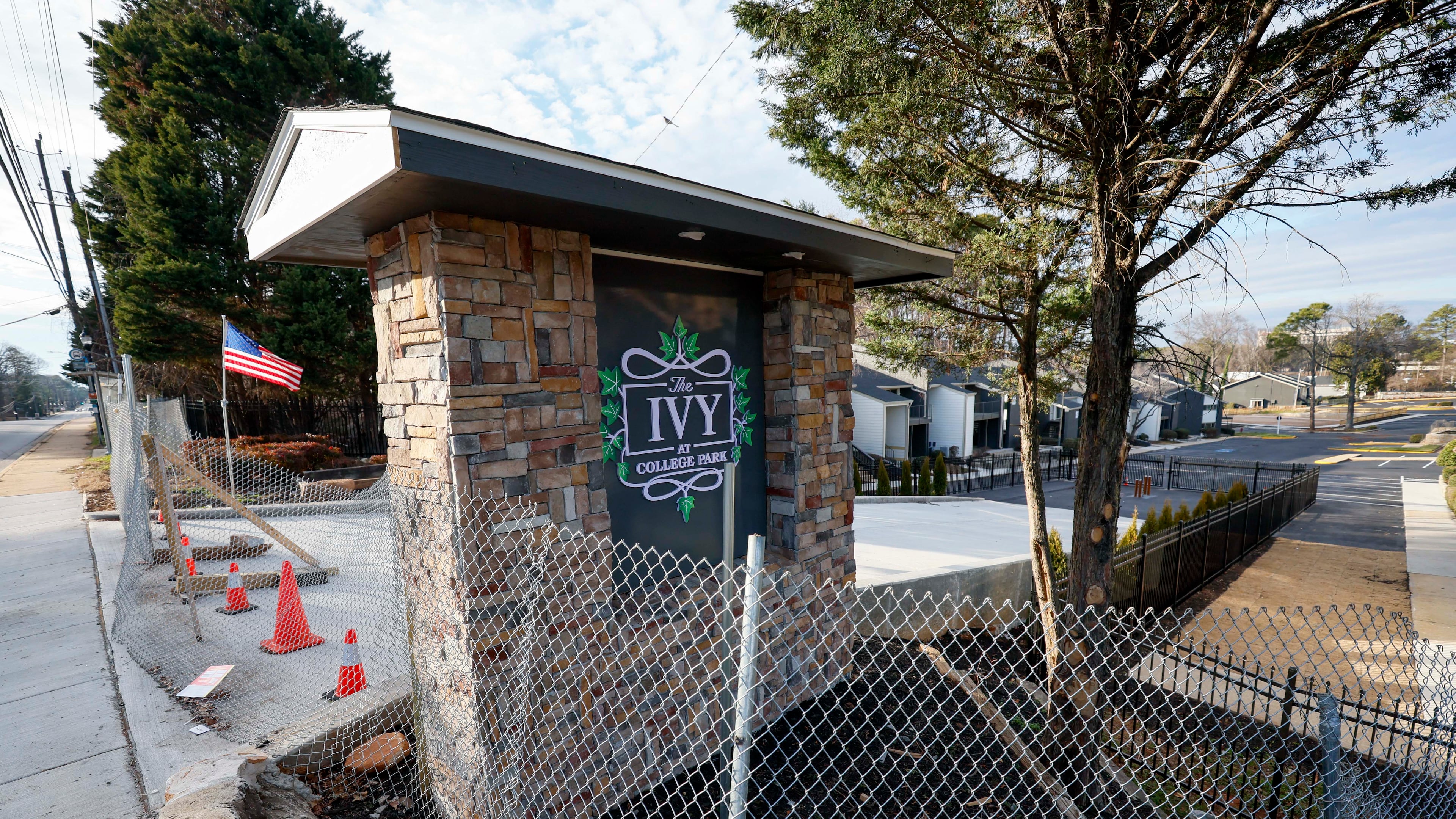 The main entrance to the Ivy at College Park, previously called Chelsea Gardens, is seen fenced off on Tuesday, Feb. 3, 2026. The apartment complex is at the center of a lawsuit alleging corruption and conspiracy by current and former College Park city officials and others. (Miguel Martinez/AJC)