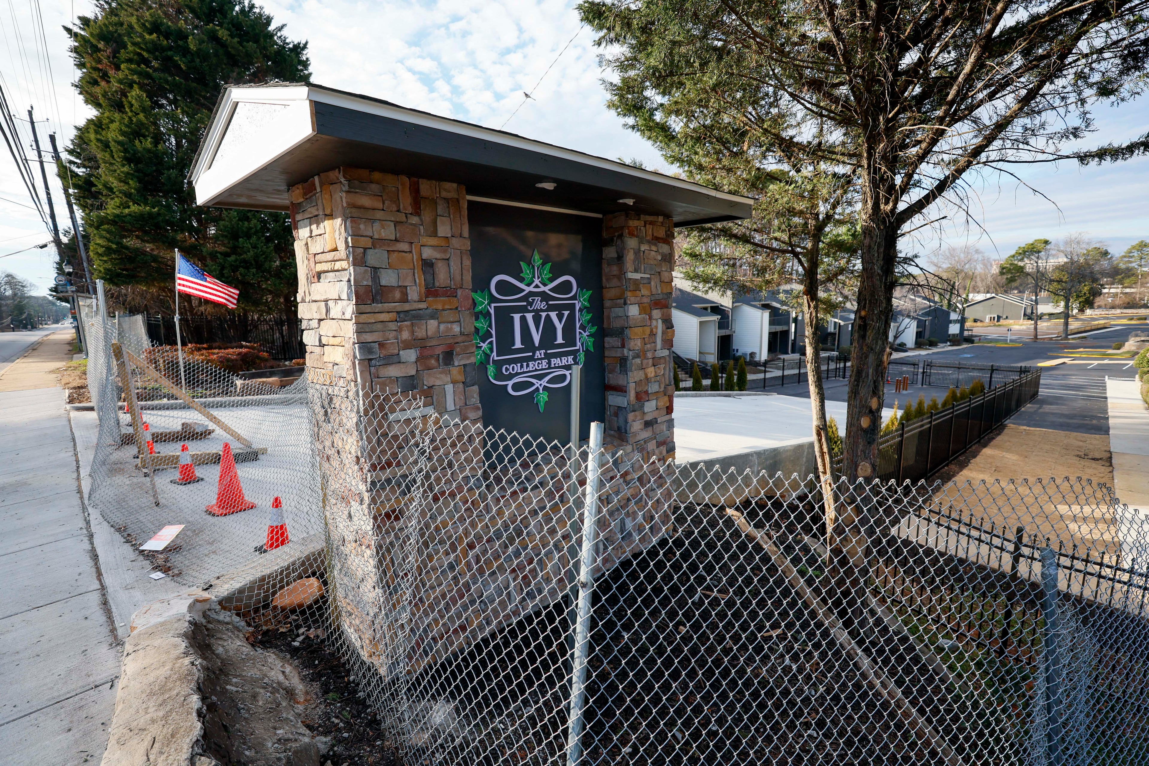 The main entrance to the Ivy at College Park, previously called Chelsea Gardens, is seen fenced off on Tuesday, Feb. 3, 2026. The apartment complex is at the center of a lawsuit alleging corruption and conspiracy by current and former College Park city officials and others. (Miguel Martinez/AJC)