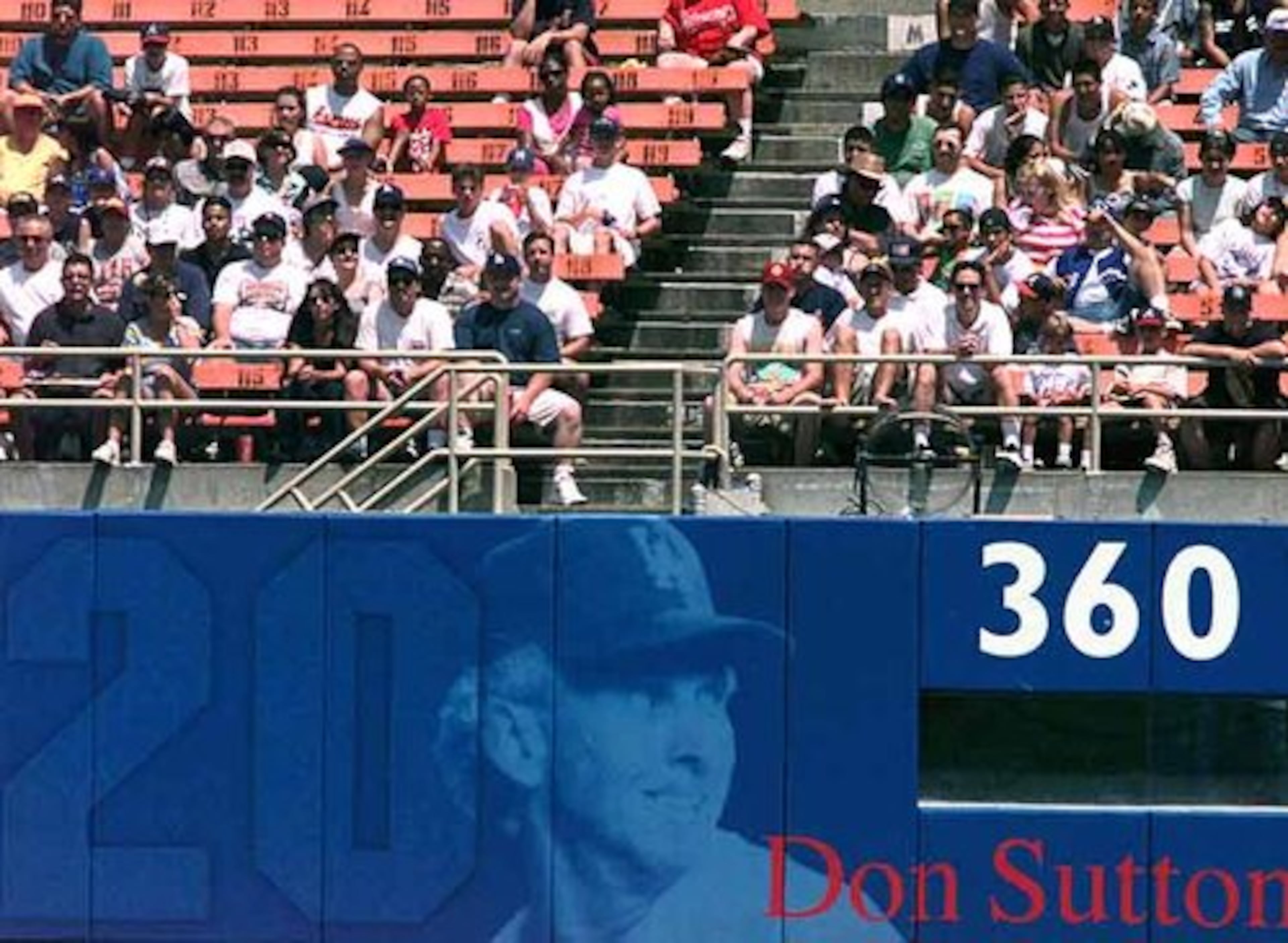 Fans sit above the right field mural at Dodger Stadium honoring Sutton, whose #20 has been retired by L.A.
