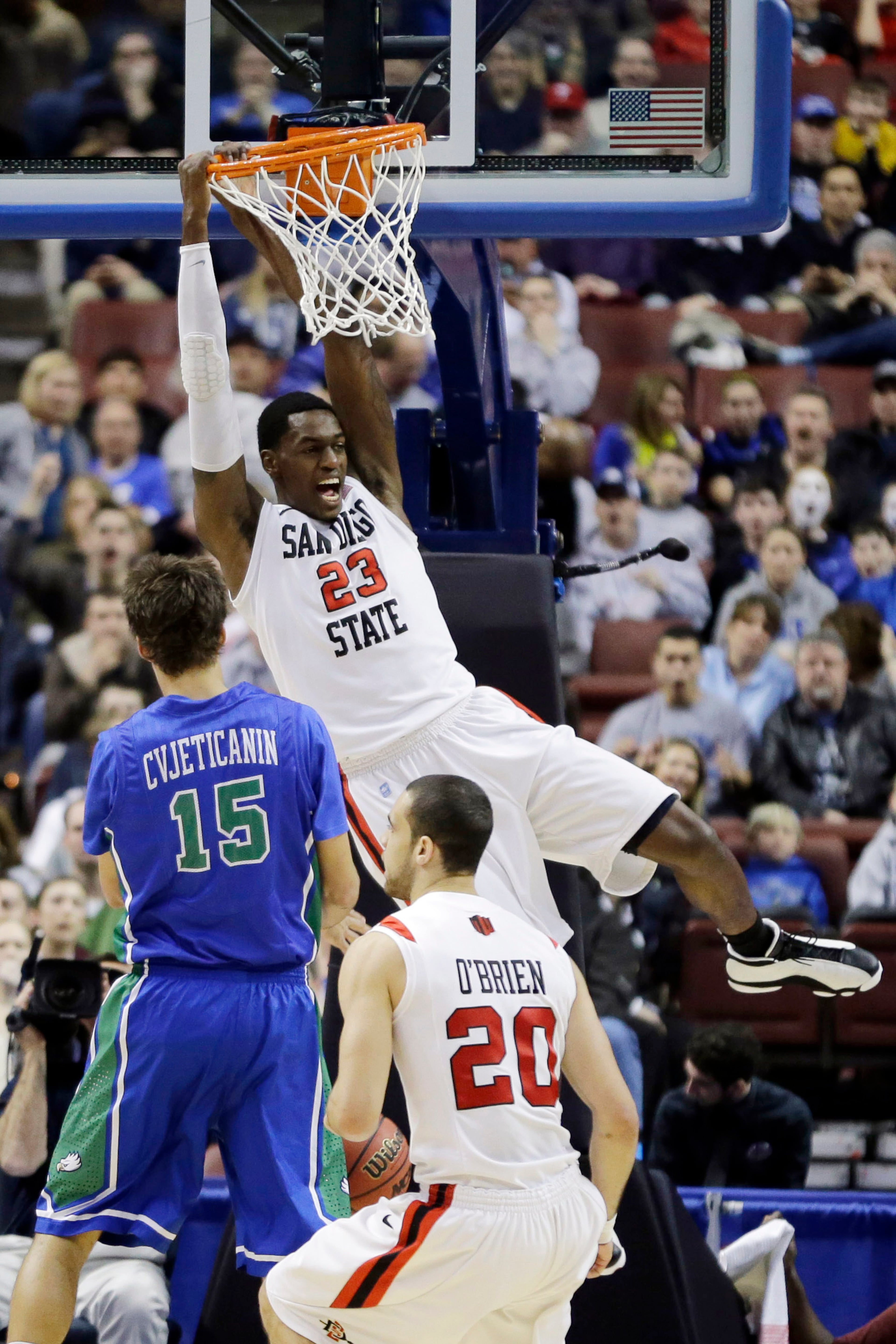 San Diego State's Deshawn Stephens (23) reacts after a dunk past JJ O'Brien (20) and Florida Gulf Coast's Filip Cvjeticanin (15) during the first half of a third-round game of the NCAA college basketball tournament, Sunday, March 24, 2013, in Philadelphia. (AP Photo/Matt Slocum)