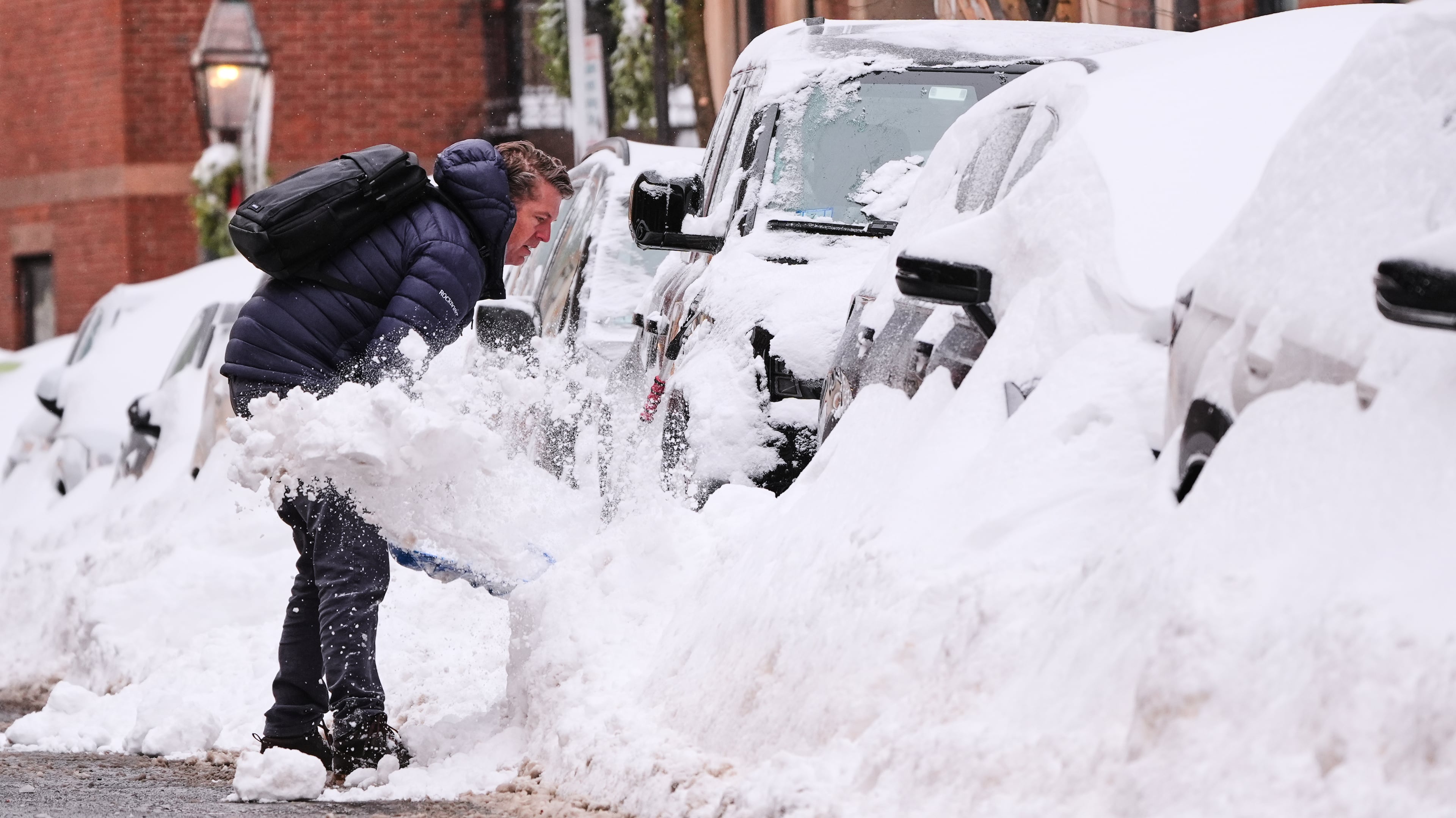 A man digs out his car on Beacon Hill following a winter storm that dump more than a foot of snow across the region, Monday, Jan. 26, 2026, in Boston. (AP Photo/Charles Krupa)