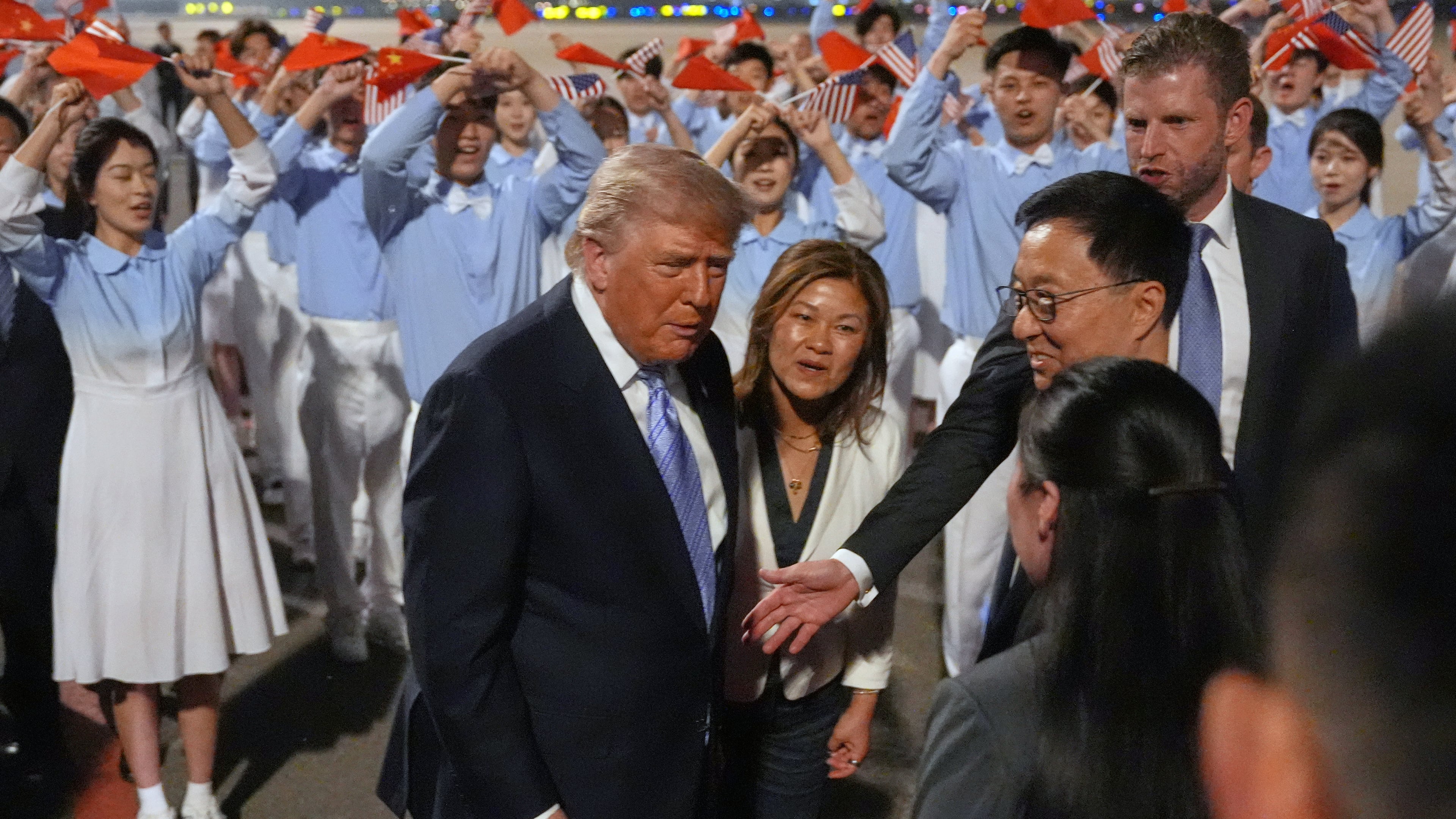 President Donald Trump talks during an arrival ceremony Wednesday, May 13, 2026, at Beijing Capital International Airport in Beijing, with Eric Trump, right. (AP Photo/Mark Schiefelbein)