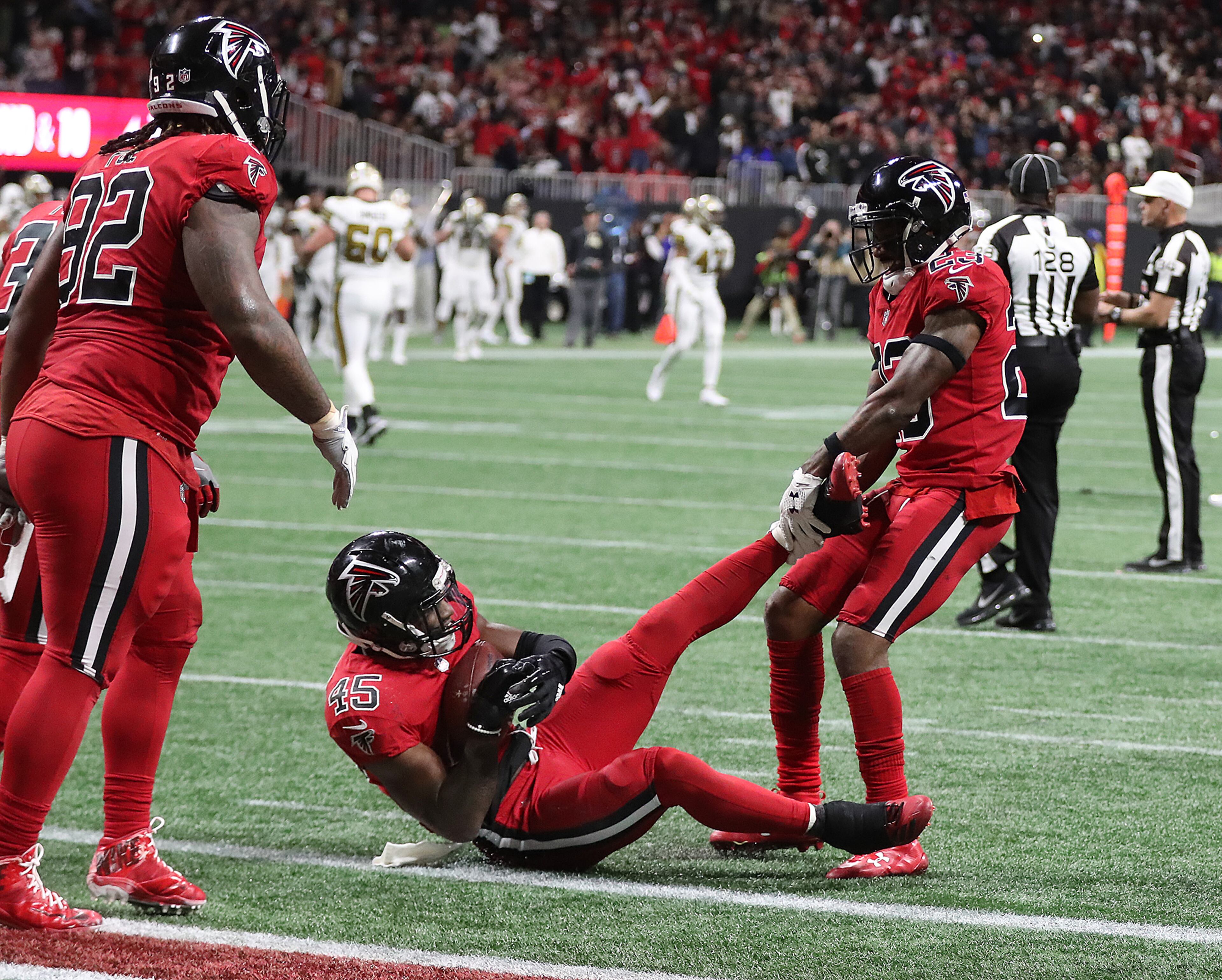 December 7, 2017 Atlanta: The celebration begins as Falcons linebacker Deion Jones hits the ground intercepting Saints quarterback Drew Brees pass intended for tight end Josh Hill in the endzone to hold on to a 20-17 victory in a NFL football game on Thursday, December 7, 2017, in Atlanta. Curtis Compton/ccompton@ajc.com