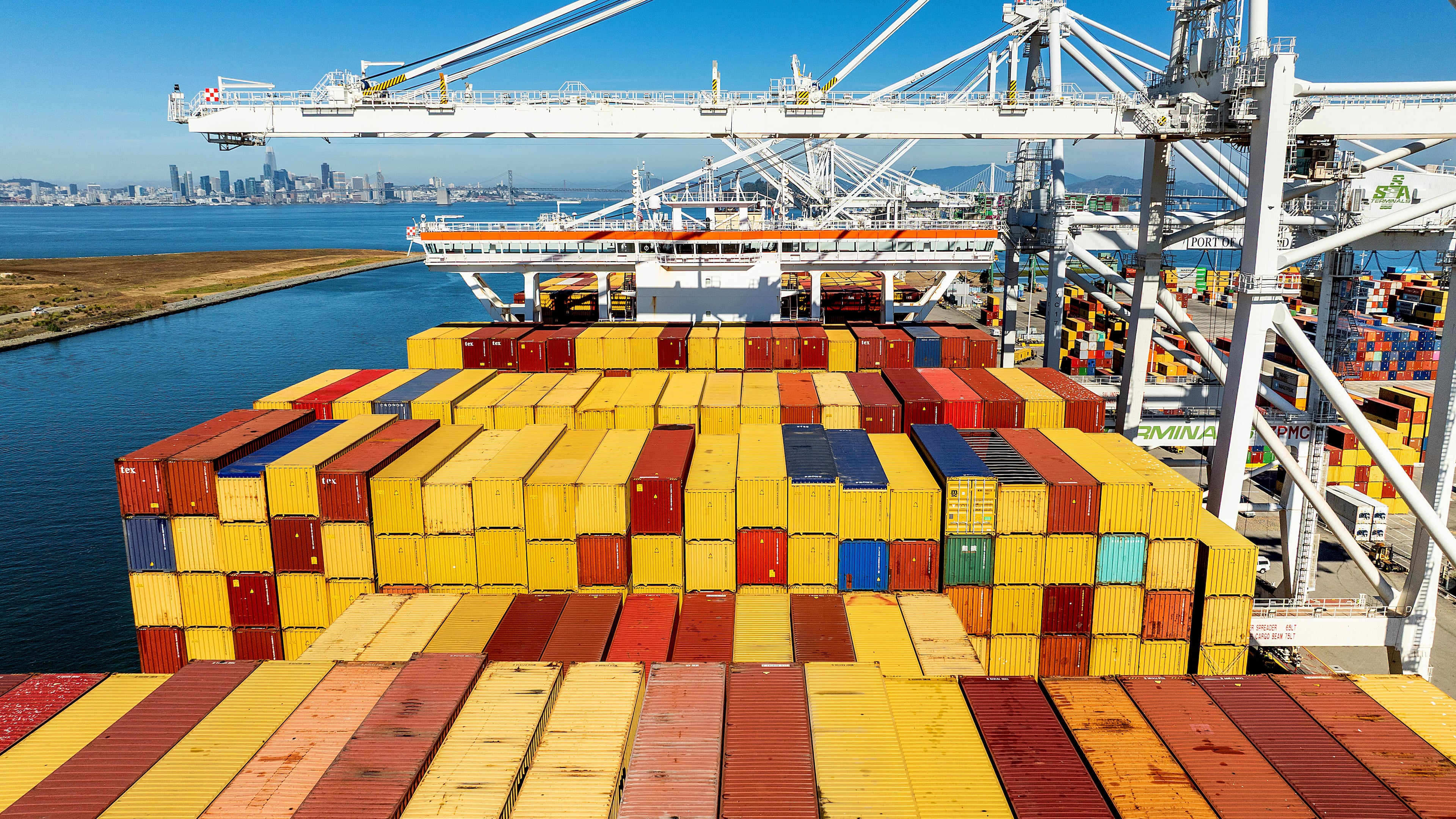 FILE - Cargo containers line a ship at the Port of Oakland on Wednesday, Aug. 6, 2025, in Oakland, Calif. (AP Photo/Noah Berger, File)