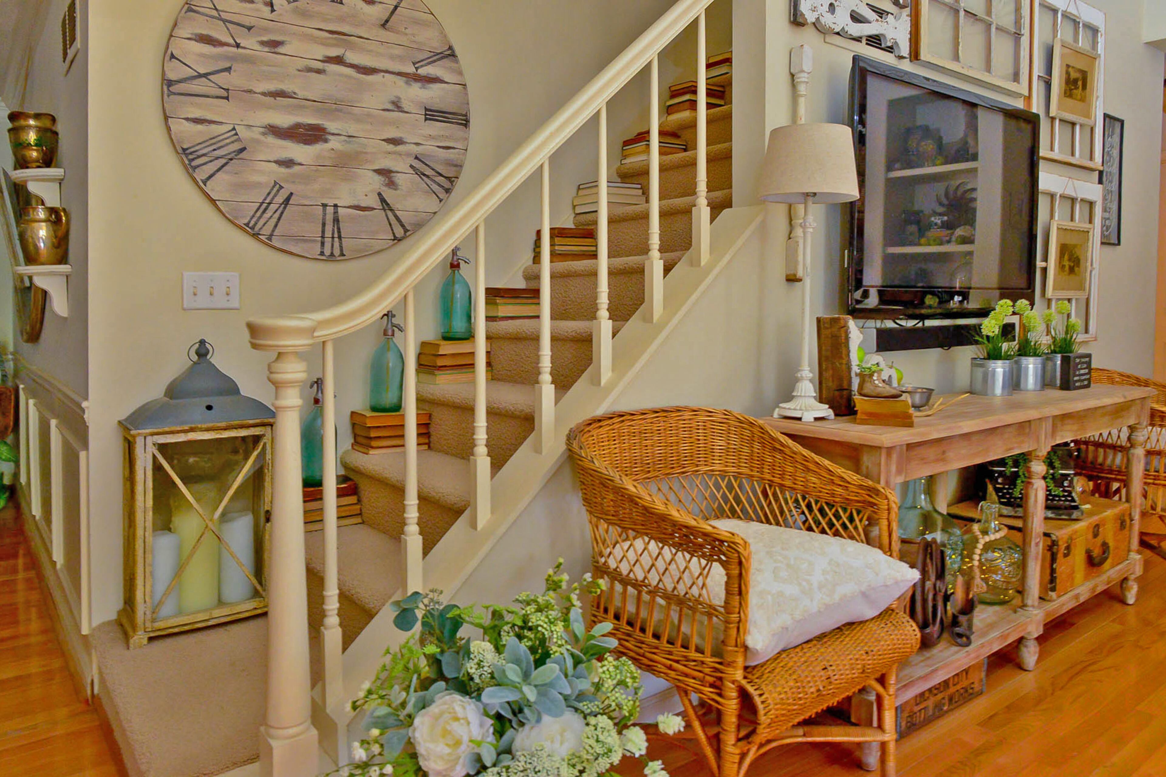 Aged books, a lantern and seltzer bottles found at an antique fair at Round Top, Texas, fair decorate the staircase leading to the loft.