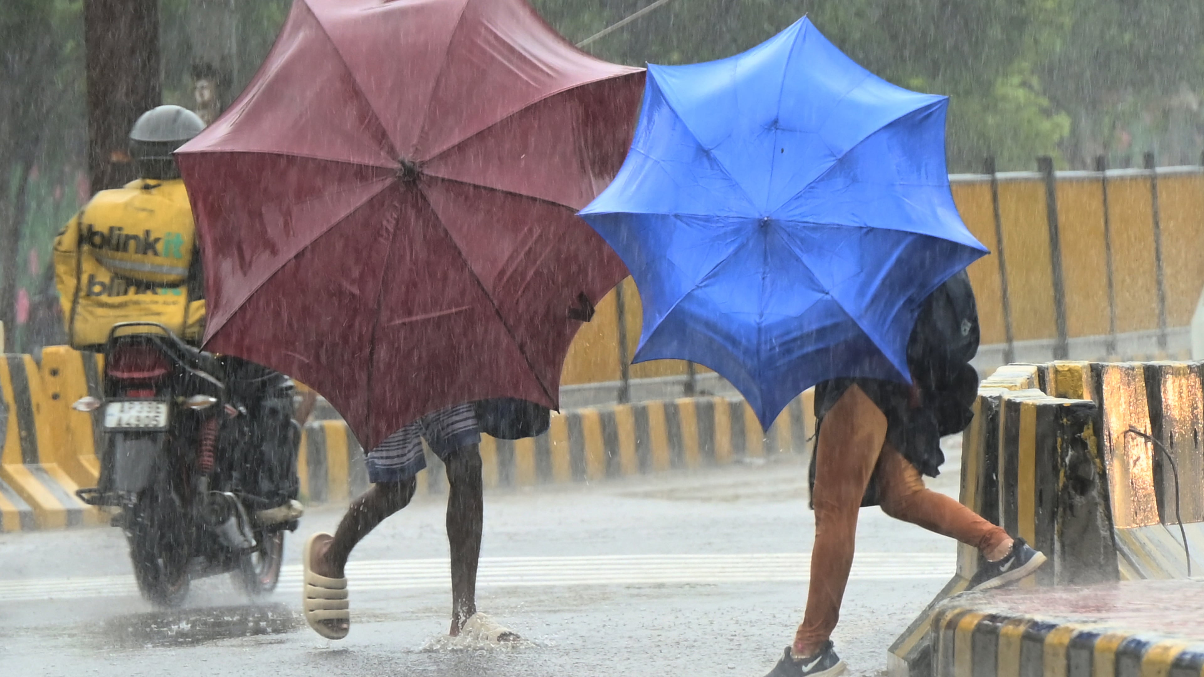 People use umbrellas to shield themselves from strong winds as Cyclone Arnab approaches the Andhra Pradesh coast, in Visakhapatnam, India, Tuesday, Oct. 27, 2026. (AP Photo)
