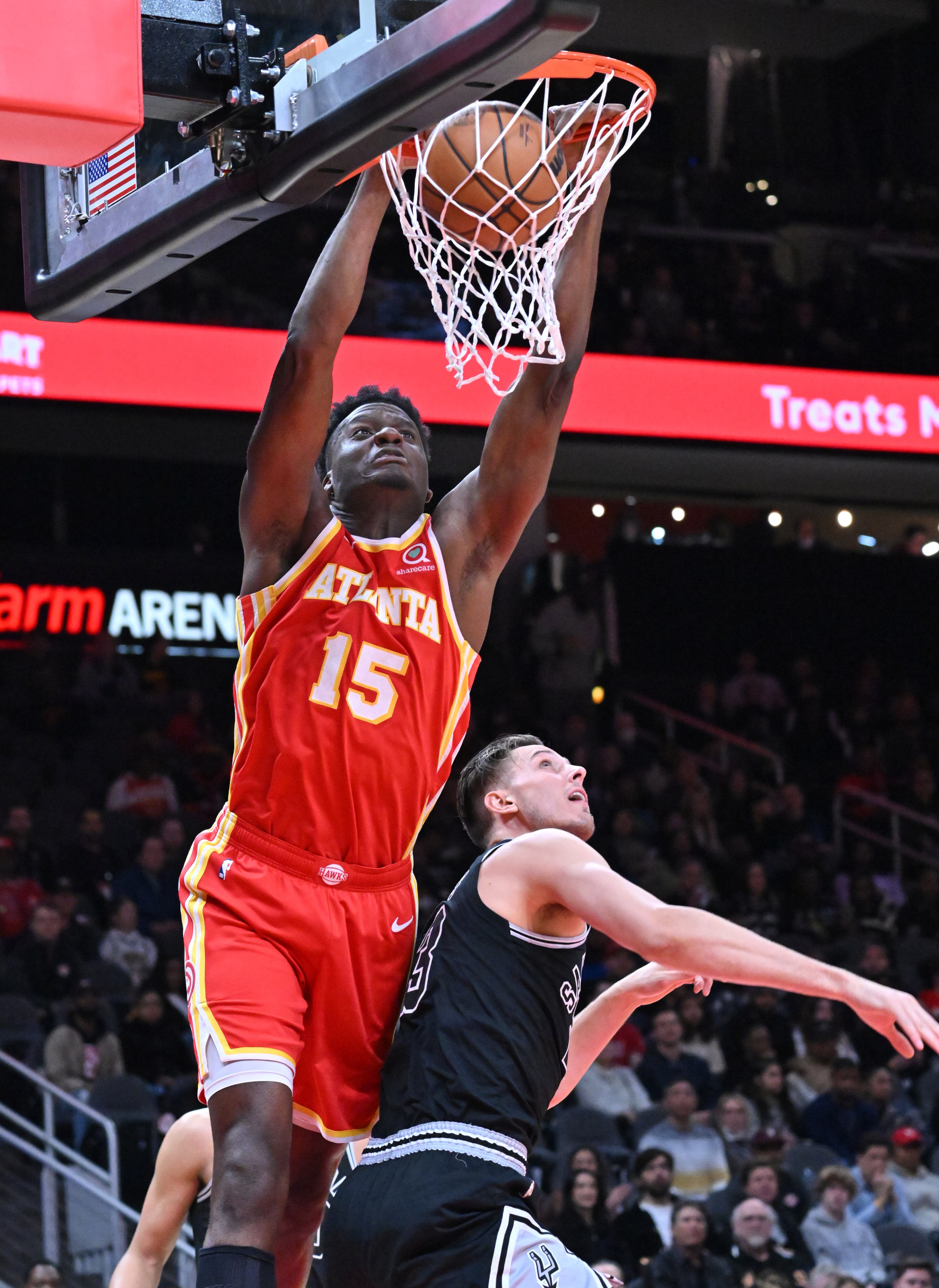 Atlanta Hawks' center Clint Capela (15) dunks over San Antonio Spurs' forward Zach Collins (23) during the first half in an NBA basketball game at State Farm Arena, Saturday, Feb. 11, 2023, in Atlanta. (Hyosub Shin / Hyosub.Shin@ajc.com)