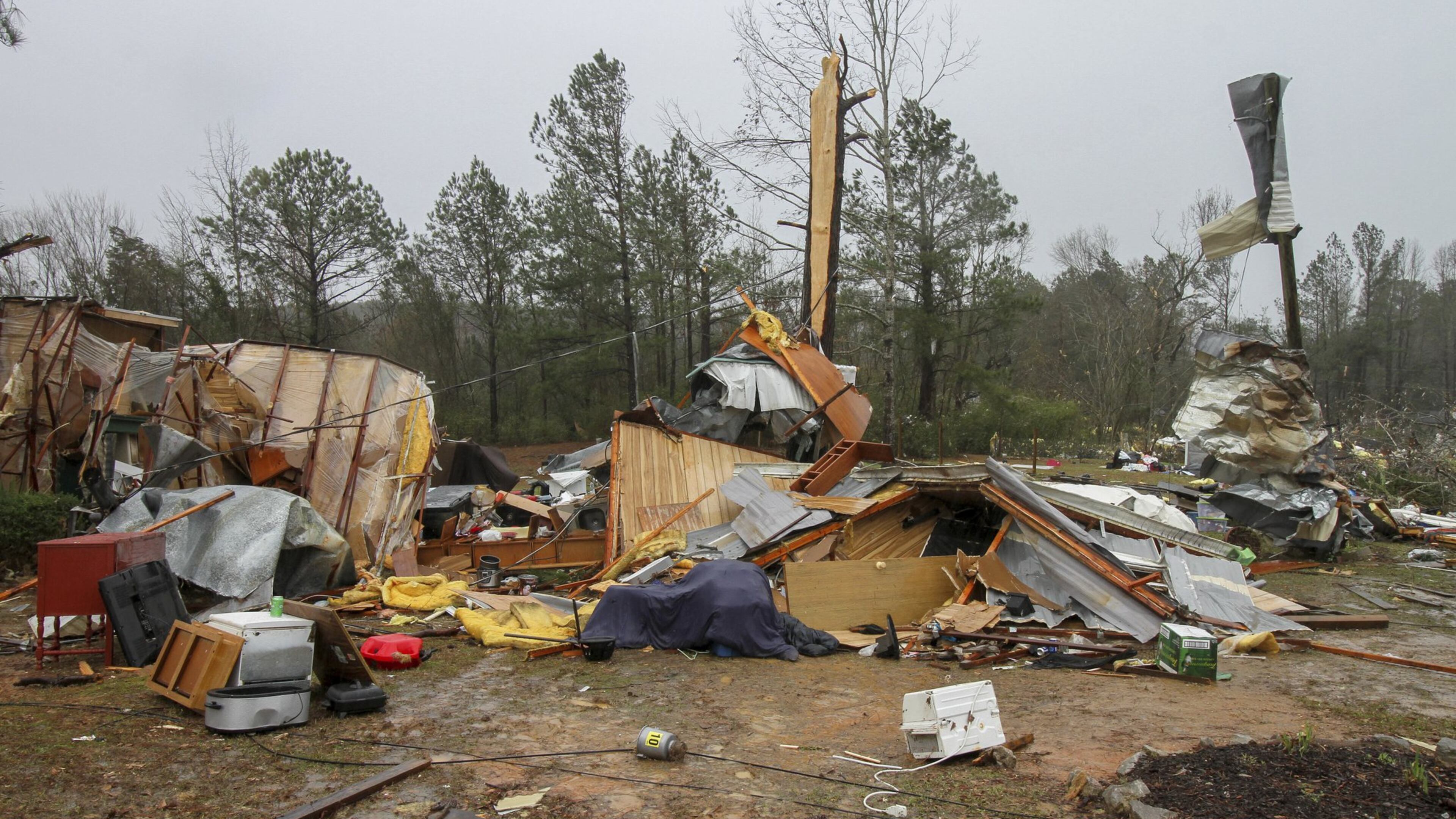 Parts of mobile homes and other property lay strewn throughout a neighborhood Sunday, Jan. 22, 2017, on Green Loop Road in Lauderdale, Miss., after a tornado passed through the area late Saturday. (Paula Merritt/The Meridian Star via AP)