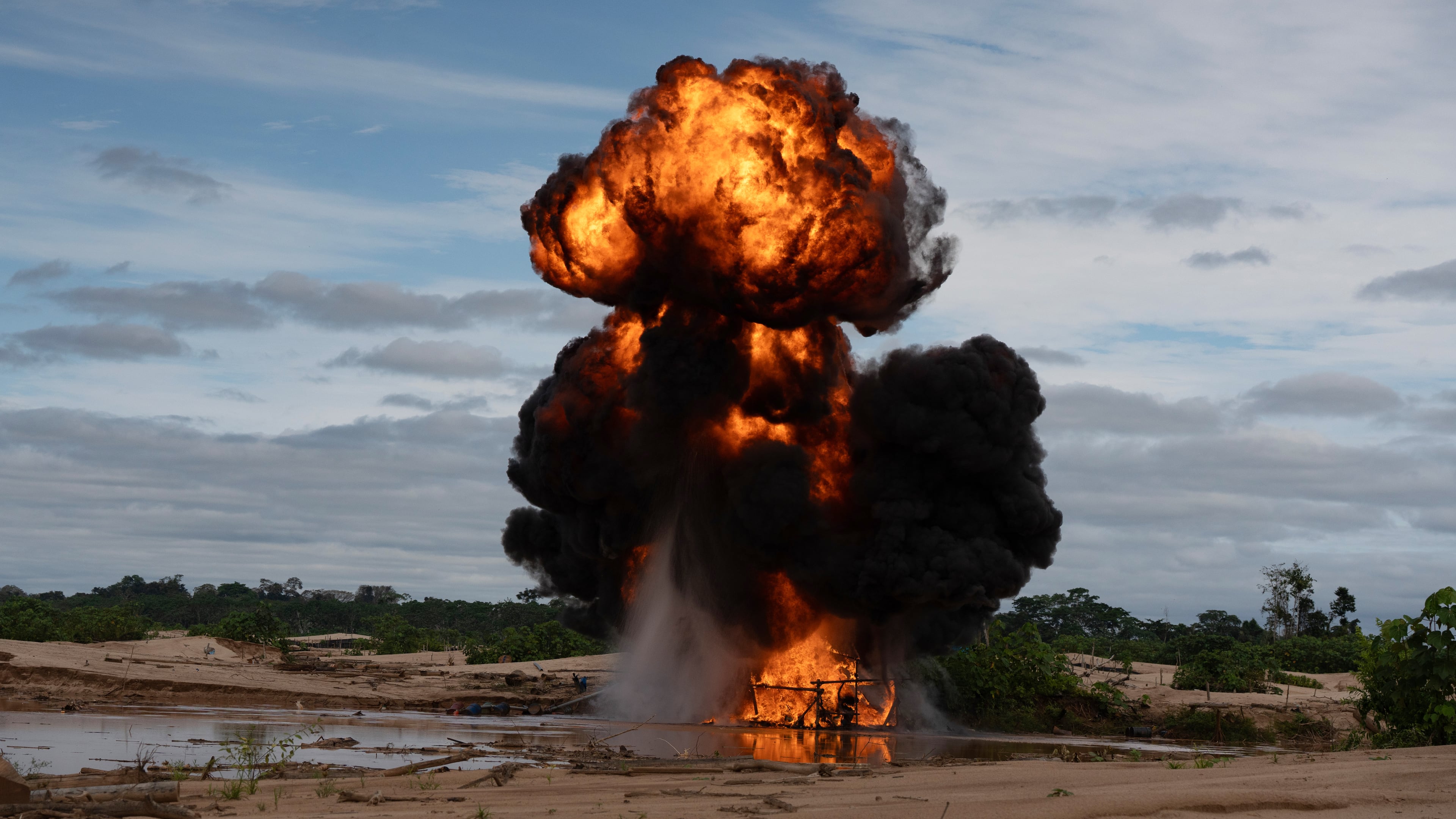 The Peruvian Navy destroys a dredge used for illegal mining near the Malinowski River in the Tambopata National Reserve in Puerto Maldonado, Peru, Tuesday, Aug. 11, 2026. (AP Photo/Guadalupe Pardo)