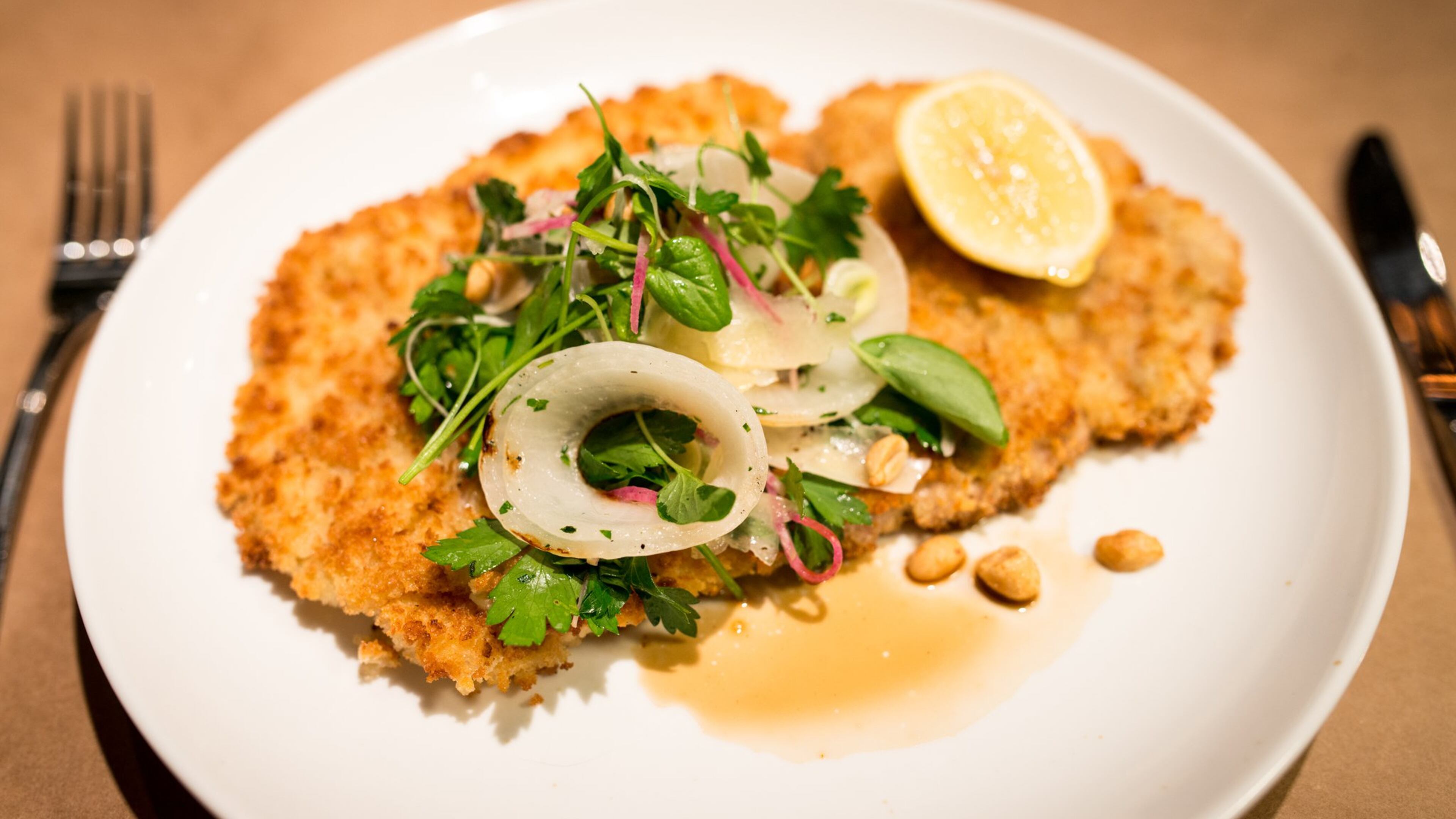 Chef Shaun Doty's pork schnitzel with onion salad, peanuts, Italian parsley. Photo credit- Mia Yakel.