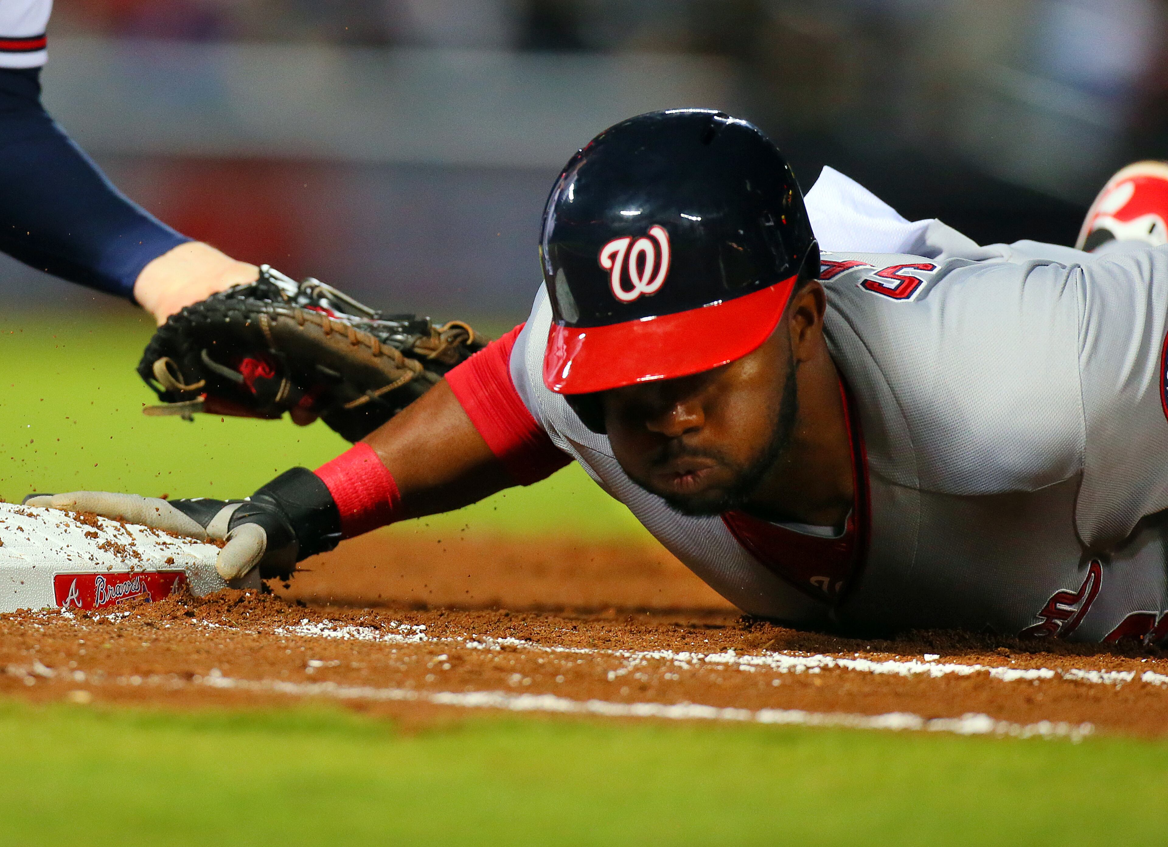 Nationals Denard Span just gets back to first safely on a pick-off attempt to Braves Freddie Freeman.