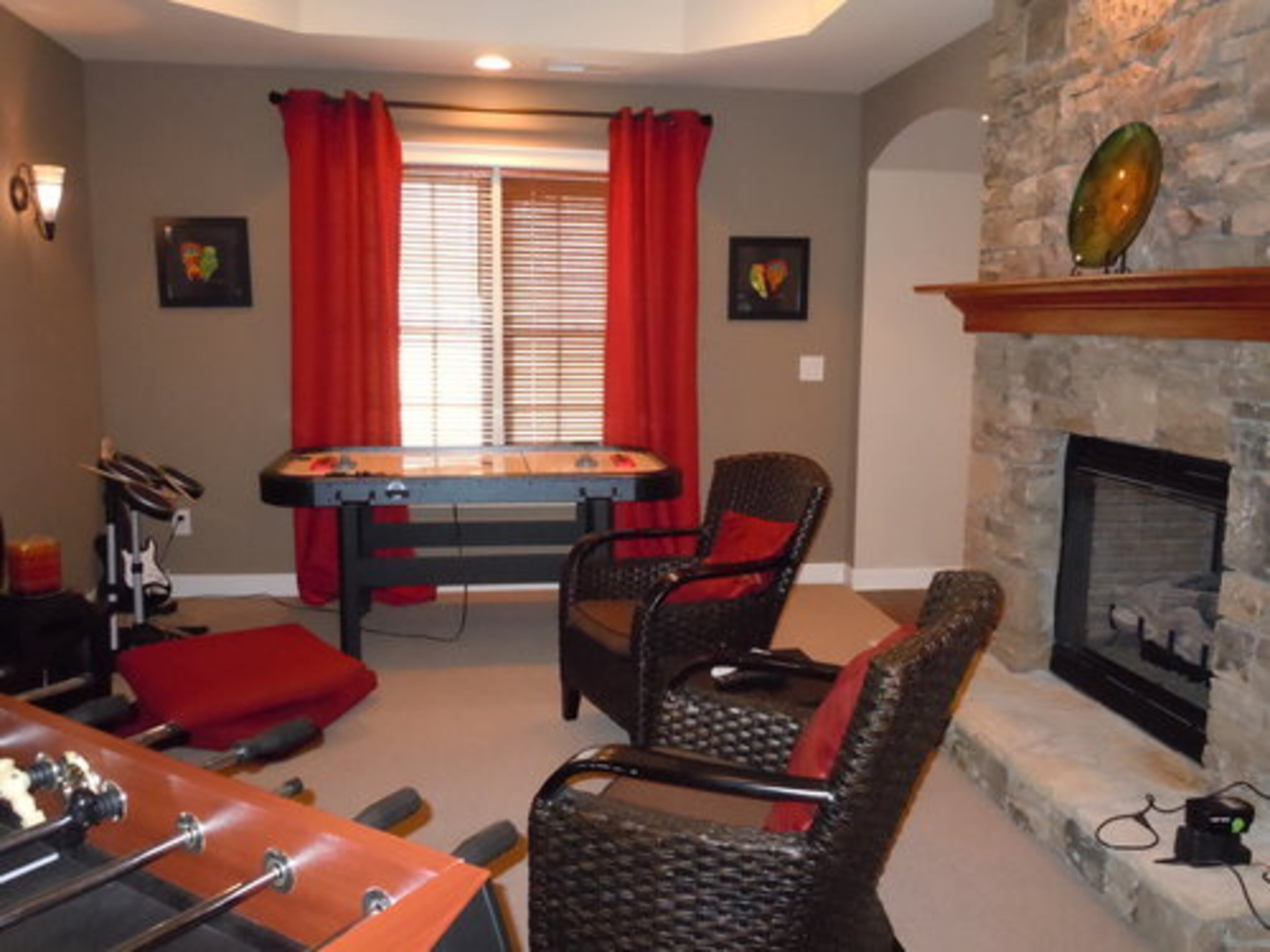 The game room is where the Dearing's teen son likes to entertain his friends with foosball and air hockey tables, video games, a drum set, guitar and a flat screen TV.