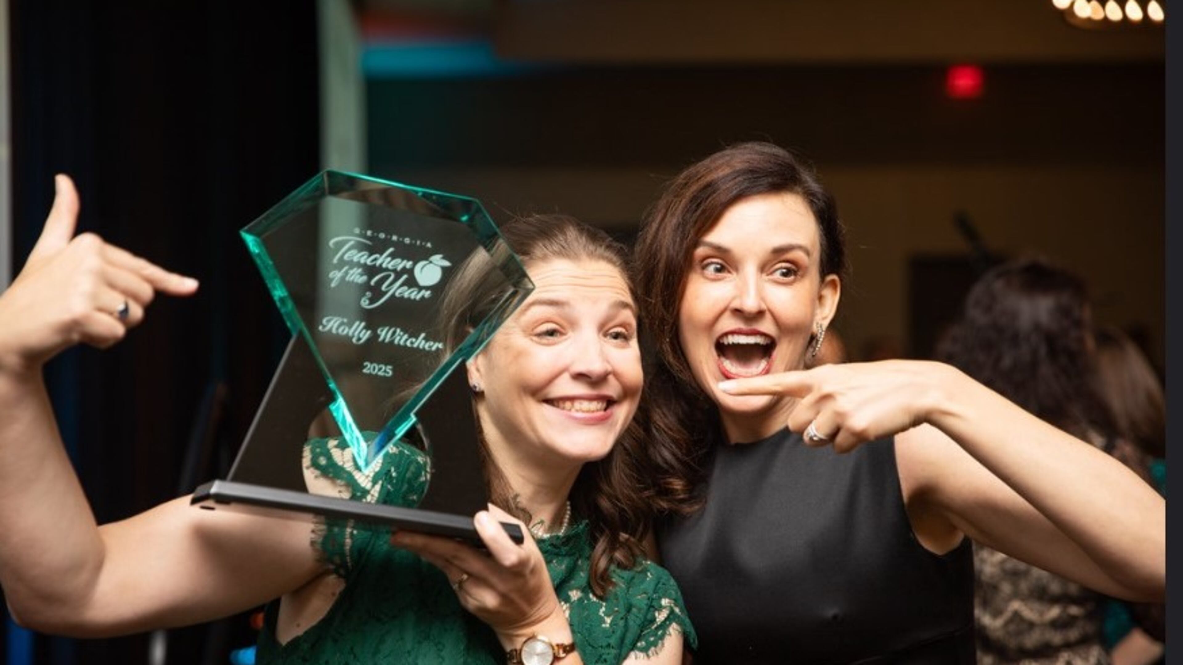 White County teacher Holly Witcher (left) celebrates being named Georgia Teacher of the Year on May 31 with the current title holder Christy Todd of Fayette County. (Courtesy of the Georgia Department of Education)
