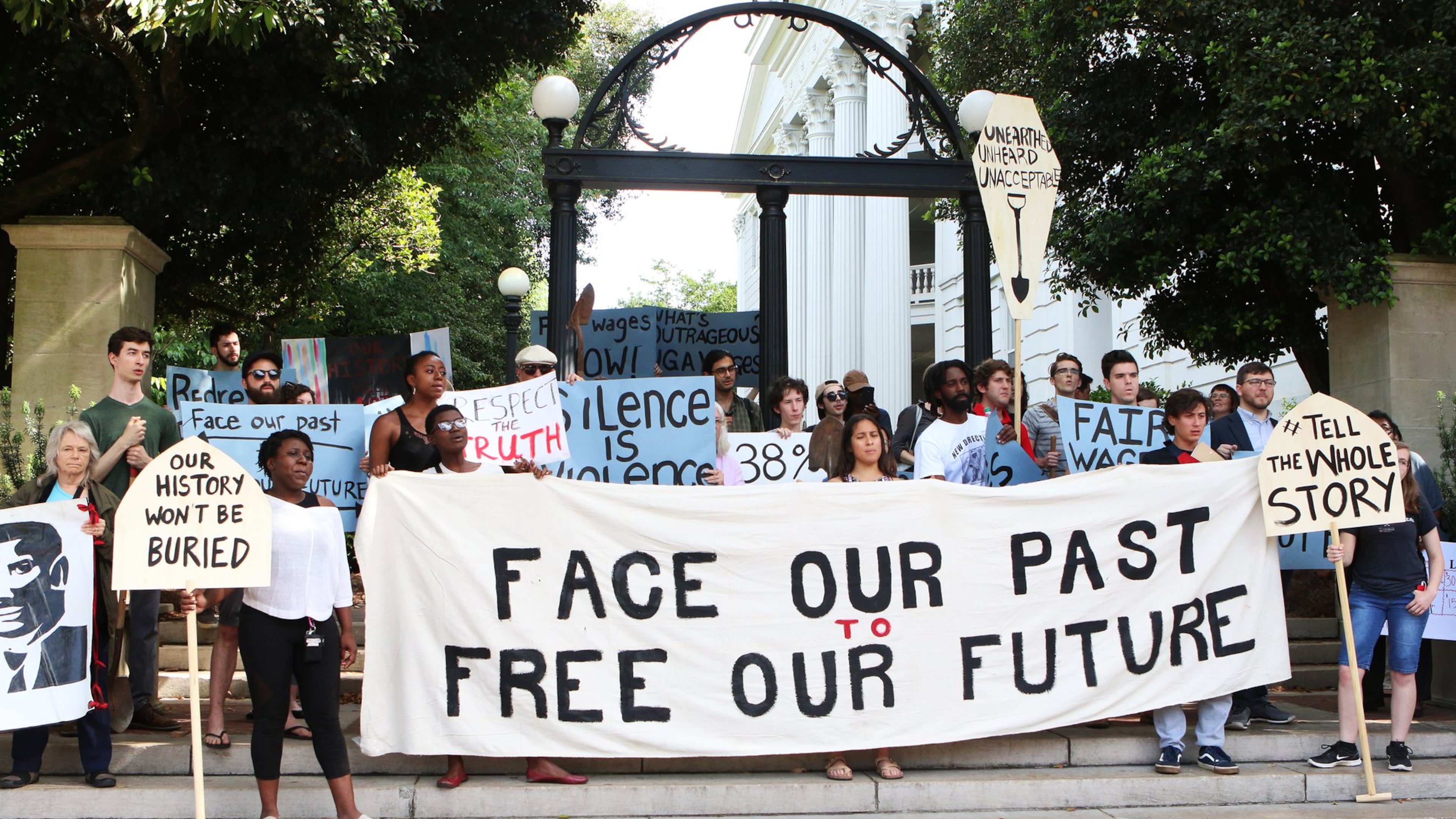 Current and former University of Georgia students, faculty and community activists gather at the Arch ahead of their march toward Baldwin Hall on May 6, 2019, in Athens. The demonstrators have pushed the school to offer various forms of reparations to address how, they say, the university has taken advantage of descendants of enslaved peoples, pay a higher working wage for university employees and give justice to the slaves who were found buried below Baldwin Hall. CONTRIBUTED BY CHRISTINA R. MATACOTTA