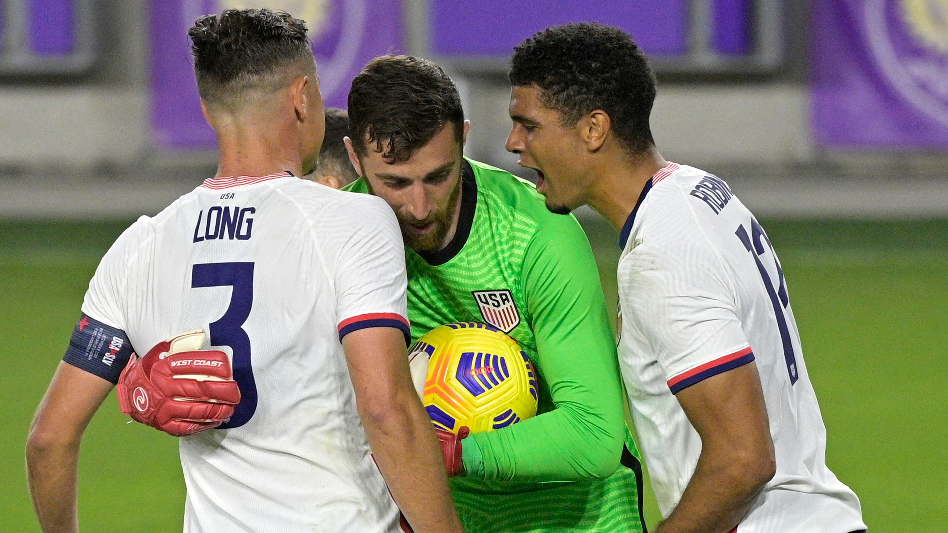 United States goalkeeper Matt Turner (center) is congratulated by defenders Aaron Long (3) and Miles Robinson (12) after stopping a penalty kick by Trinidad and Tobago defender Alvin Jones during the second half of an international friendly soccer match, Sunday, Jan. 31, 2021, in Orlando, Fla. (Phelan M. Ebenhack/AP)