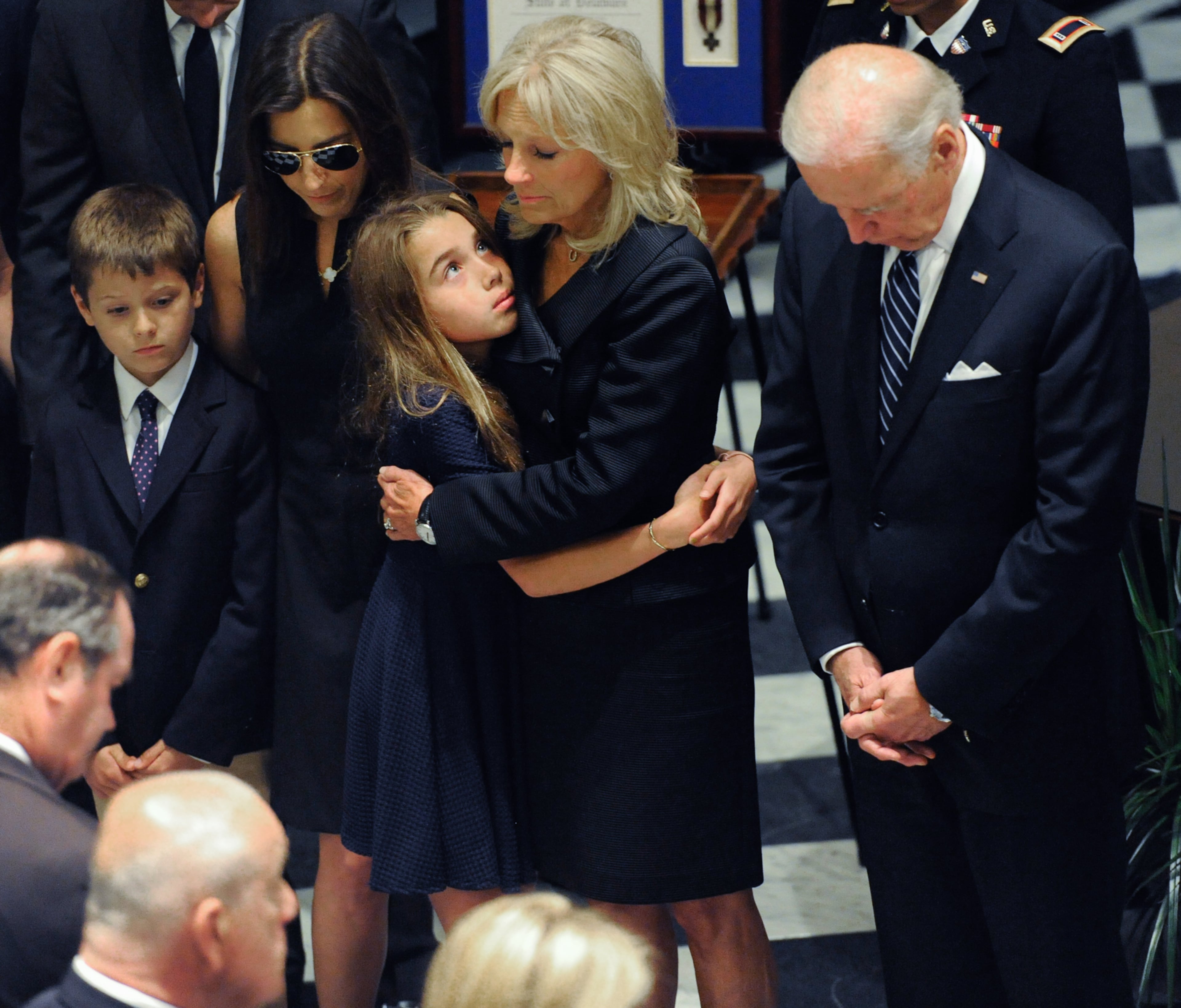 Jill Biden hugs Natalie Biden, daughter of former Delaware Attorney General Beau Biden, as Vice President Joe Biden, right, looks down during a viewing for his son, Thursday, June 4, 2015, at Legislative Hall in Dover, Del. Beau Biden died of brain cancer Saturday at age 46. (Jason Minto/The Wilmington News-Journal via AP)