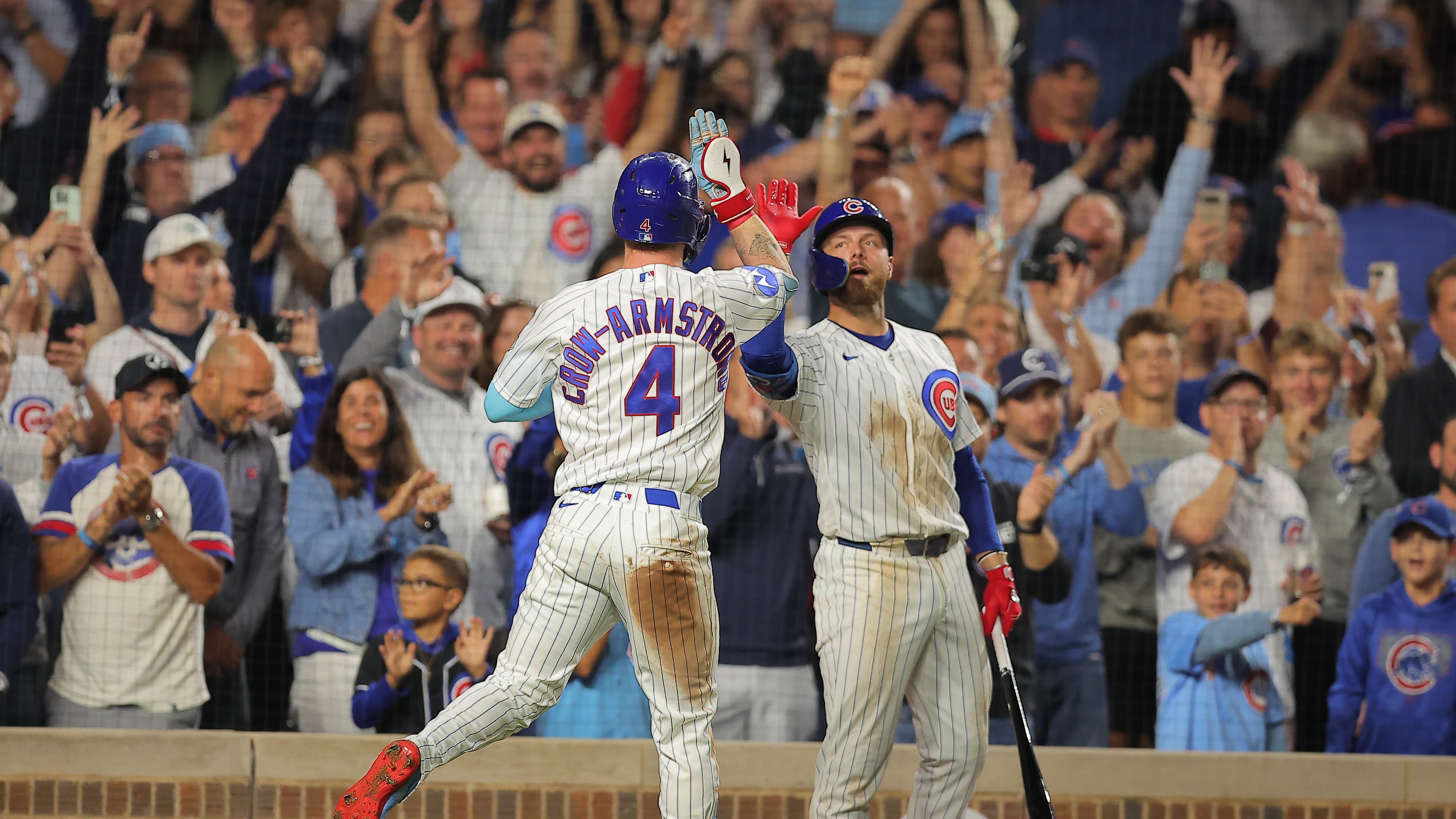 Chicago Cubs' Pete Crow-Armstrong, left, celebrates his home run with teammate Michael Busch, right, during the seventh inning of a baseball game against the Atlanta Braves, Wednesday, Sept. 16, 2026, in Chicago. (AP Photo/Melissa Tamez)