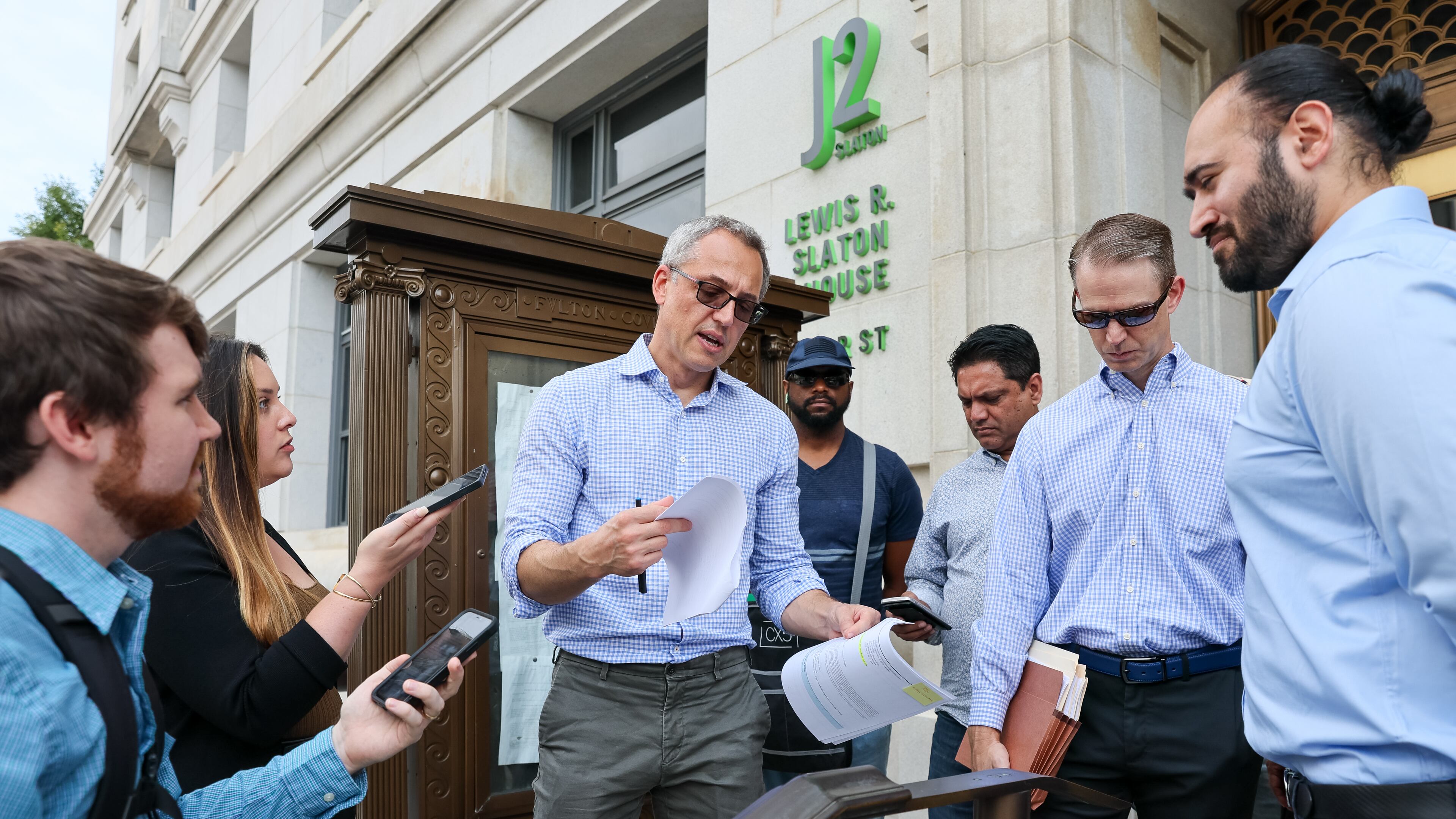 Bob Stupas, an attorney with Bryan Cave Leighton Paisner, read the 32-page foreclosure listing for Peachtree Center in front of the Fulton County Courthouse in Atlanta on Tuesday, September 6, 2022. (Arvin Temkar / arvin.temkar@ajc.com)